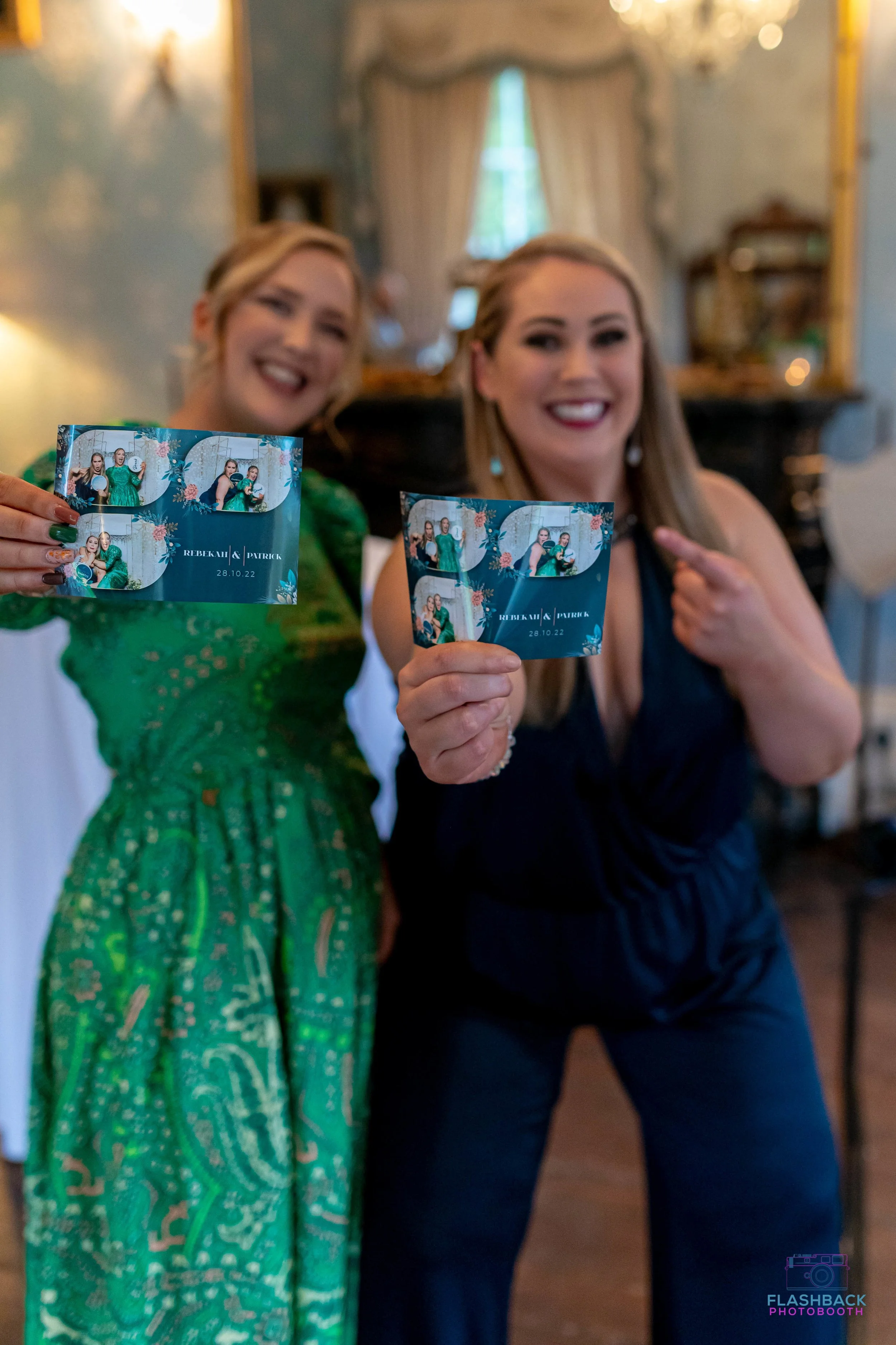 Wedding guests posing with photo booth prints in OKC