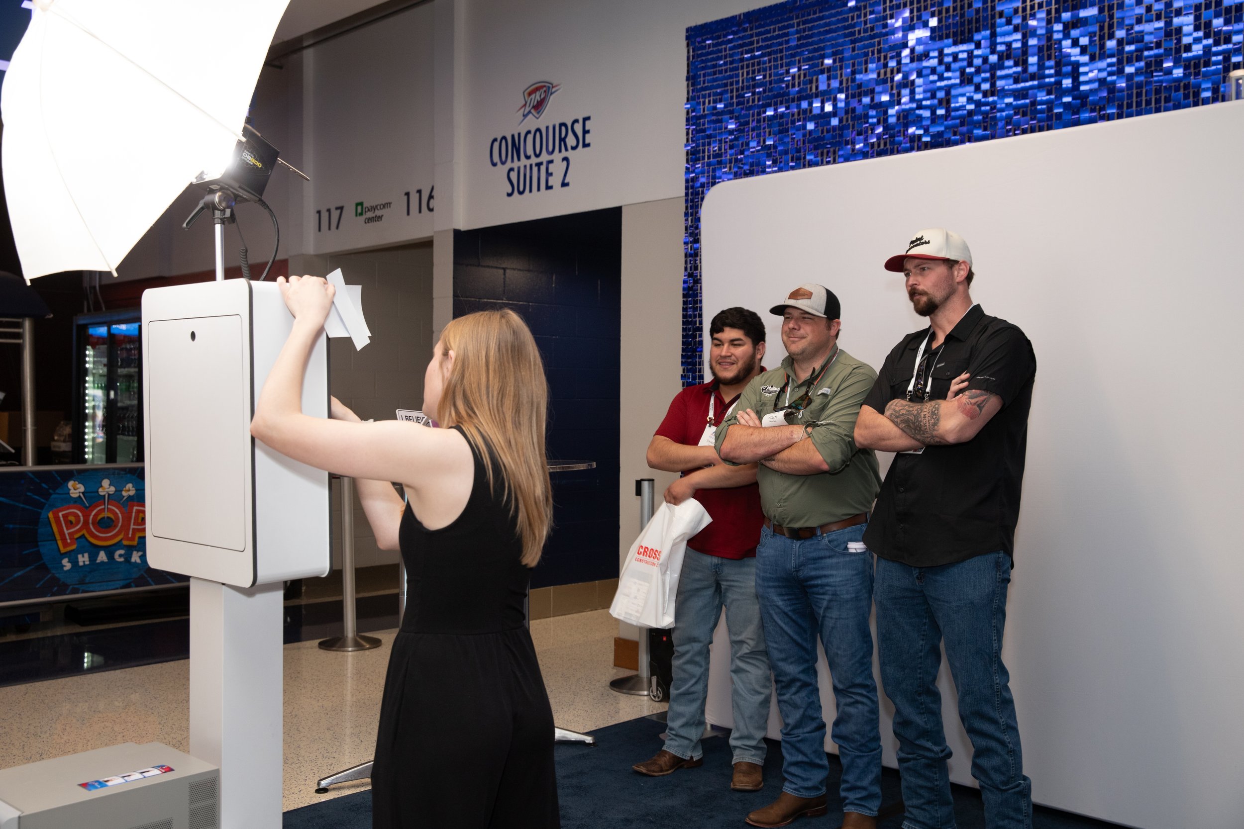 Men using photo booth at corporate event in OKC