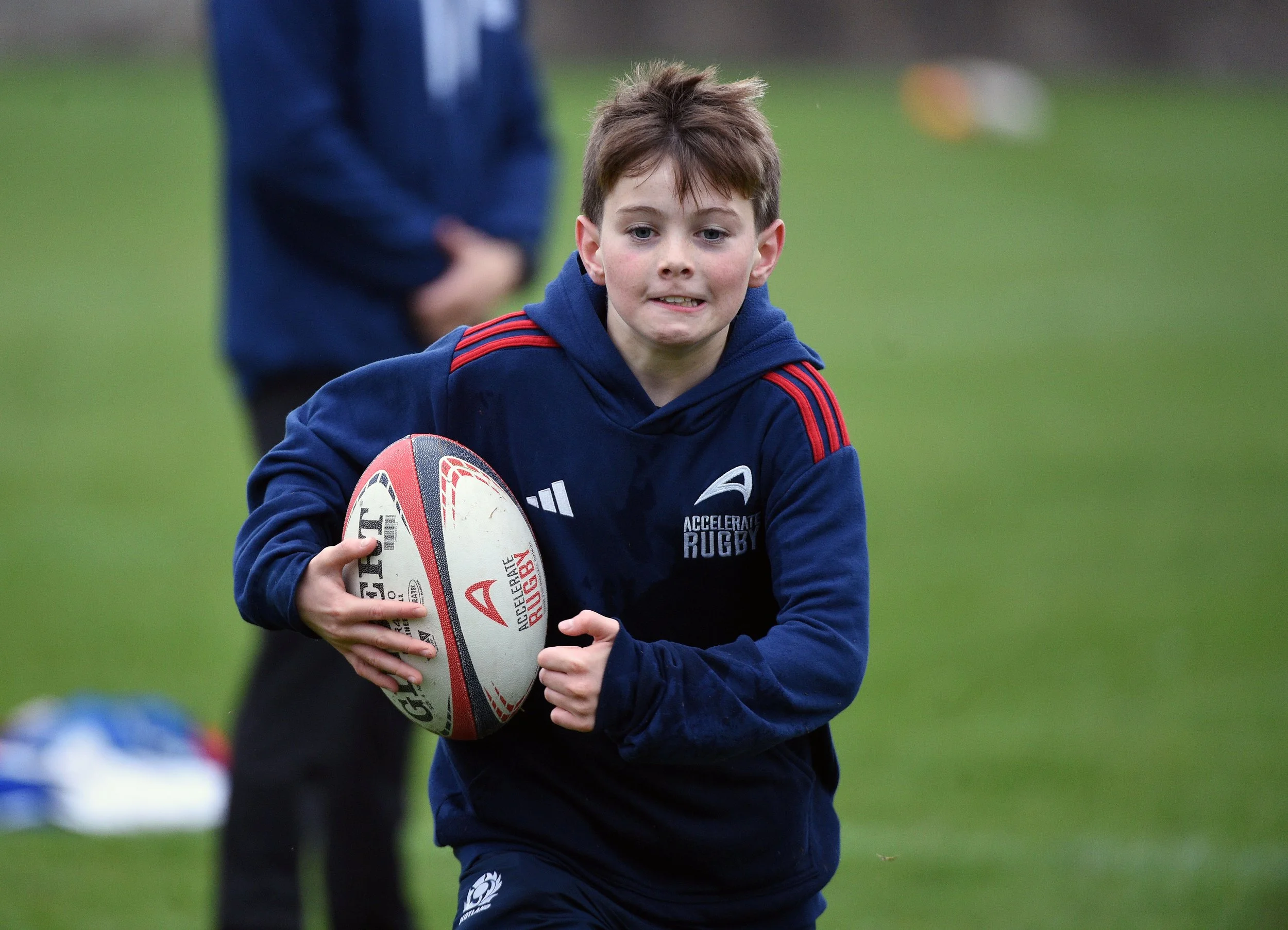 School age rugby player training scottish pitch
