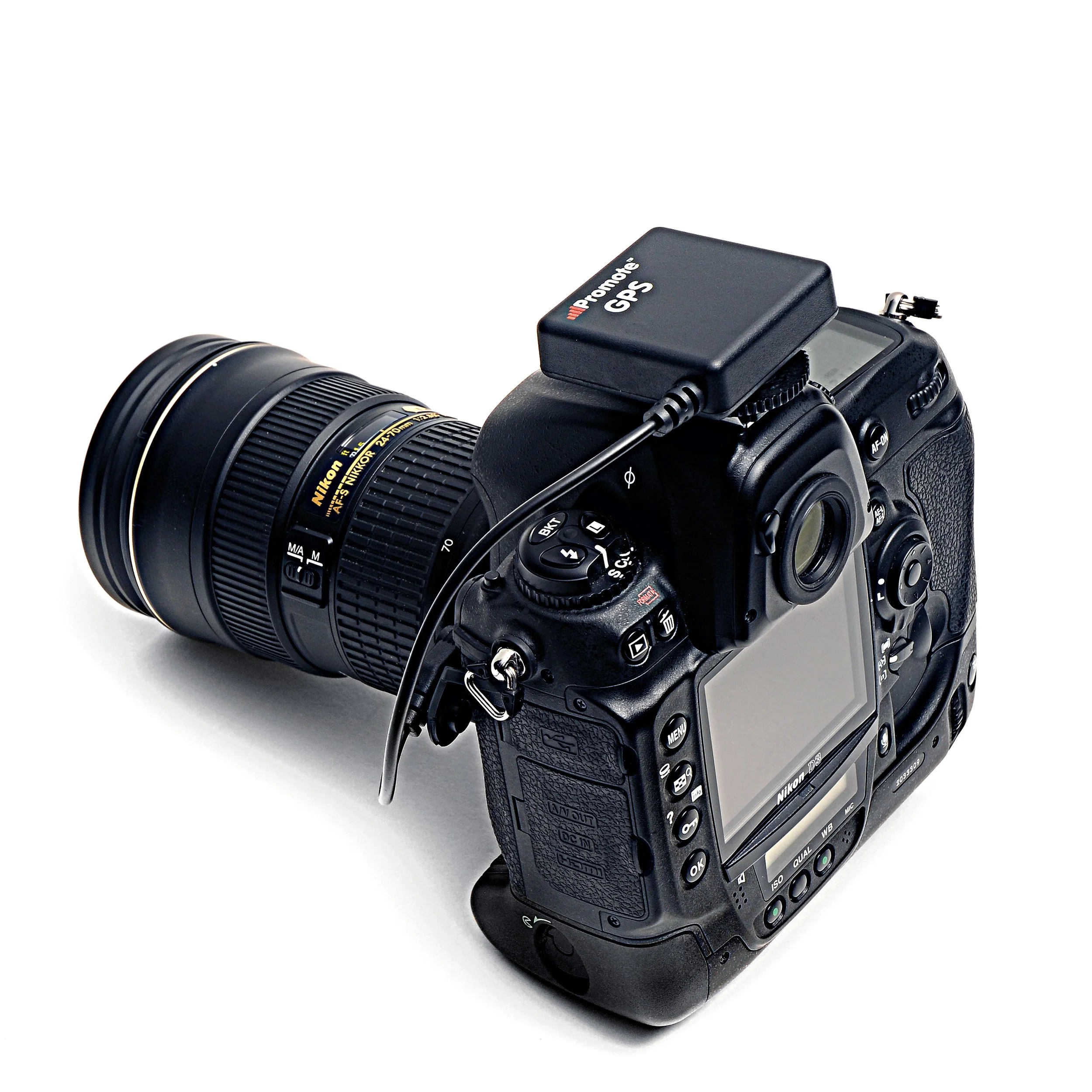 A professional DSLR camera with a large zoom lens and a GPS device mounted on top.