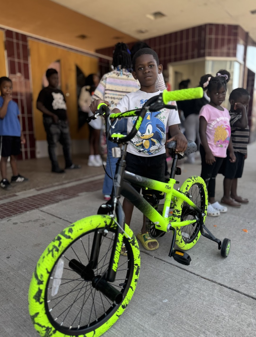 Young kid with his new bike from studioDRIFT's Bike Incentive Program.