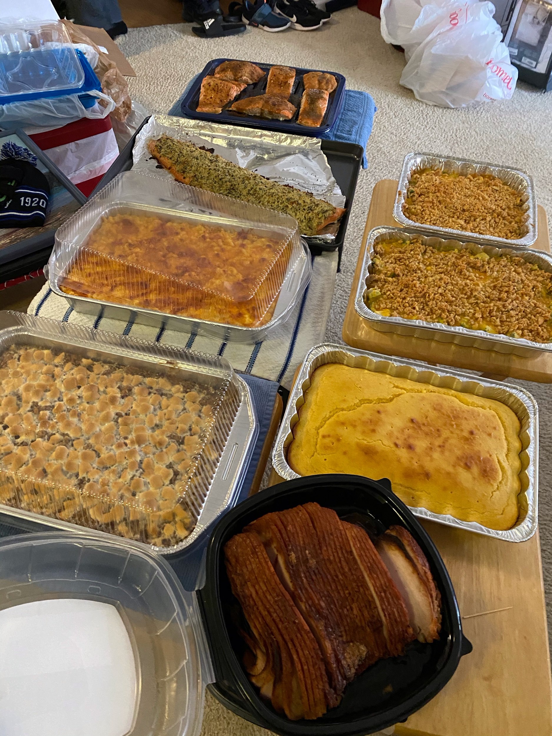 Thanksgiving dinner including Salmon, Mac n Cheese, Broccoli Casserole, Sweet Potato Souffle, Cornbread and Smoked Turkey Breast