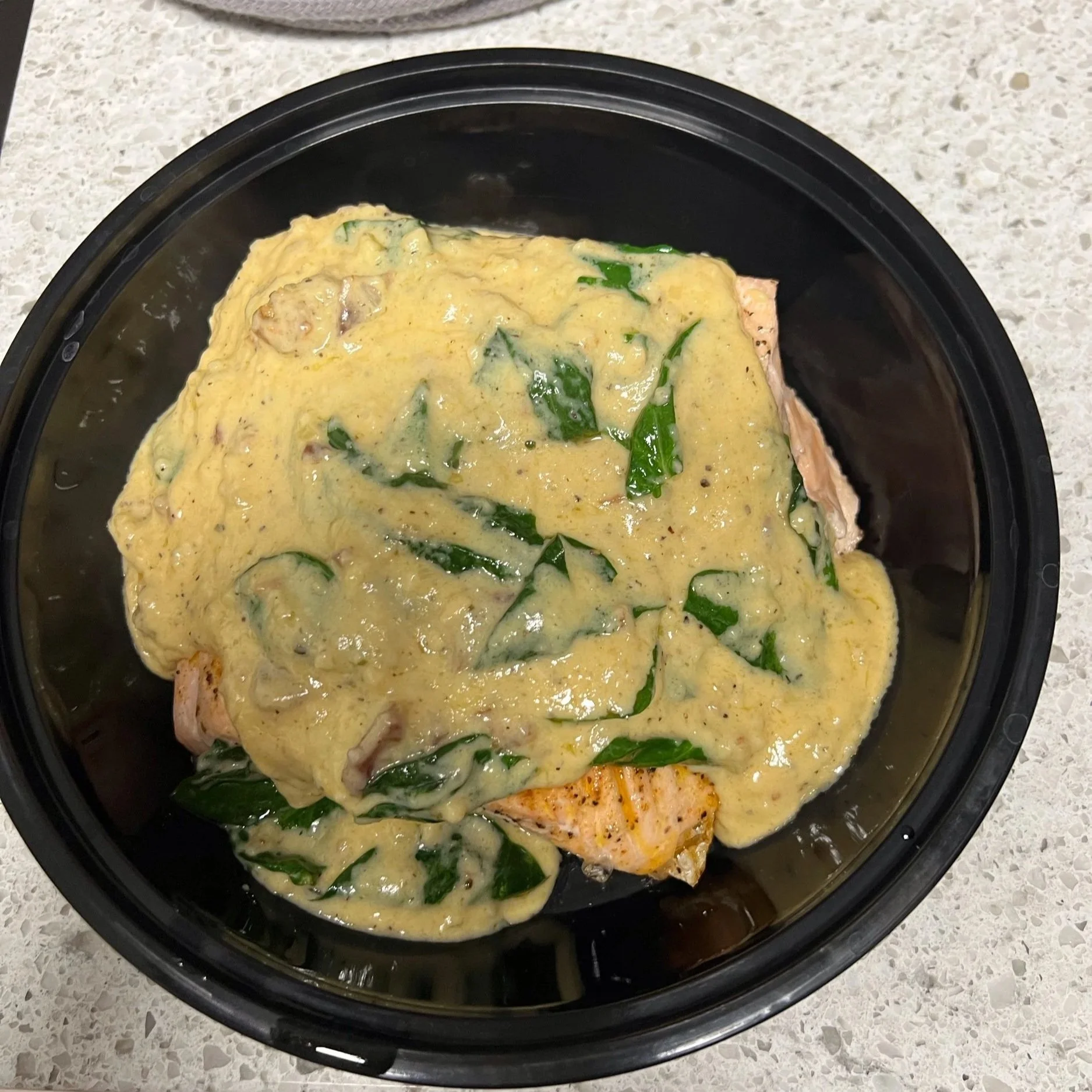 Salmon covered in a creamy spinach sauce
