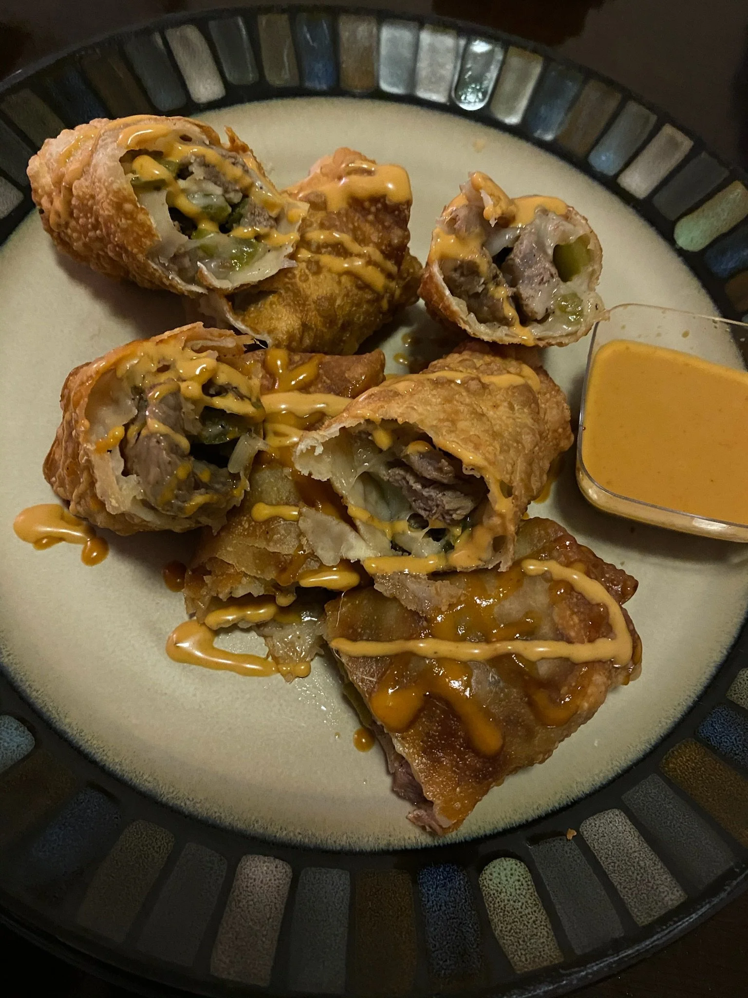Steak and cheese eggrolls with special sauce