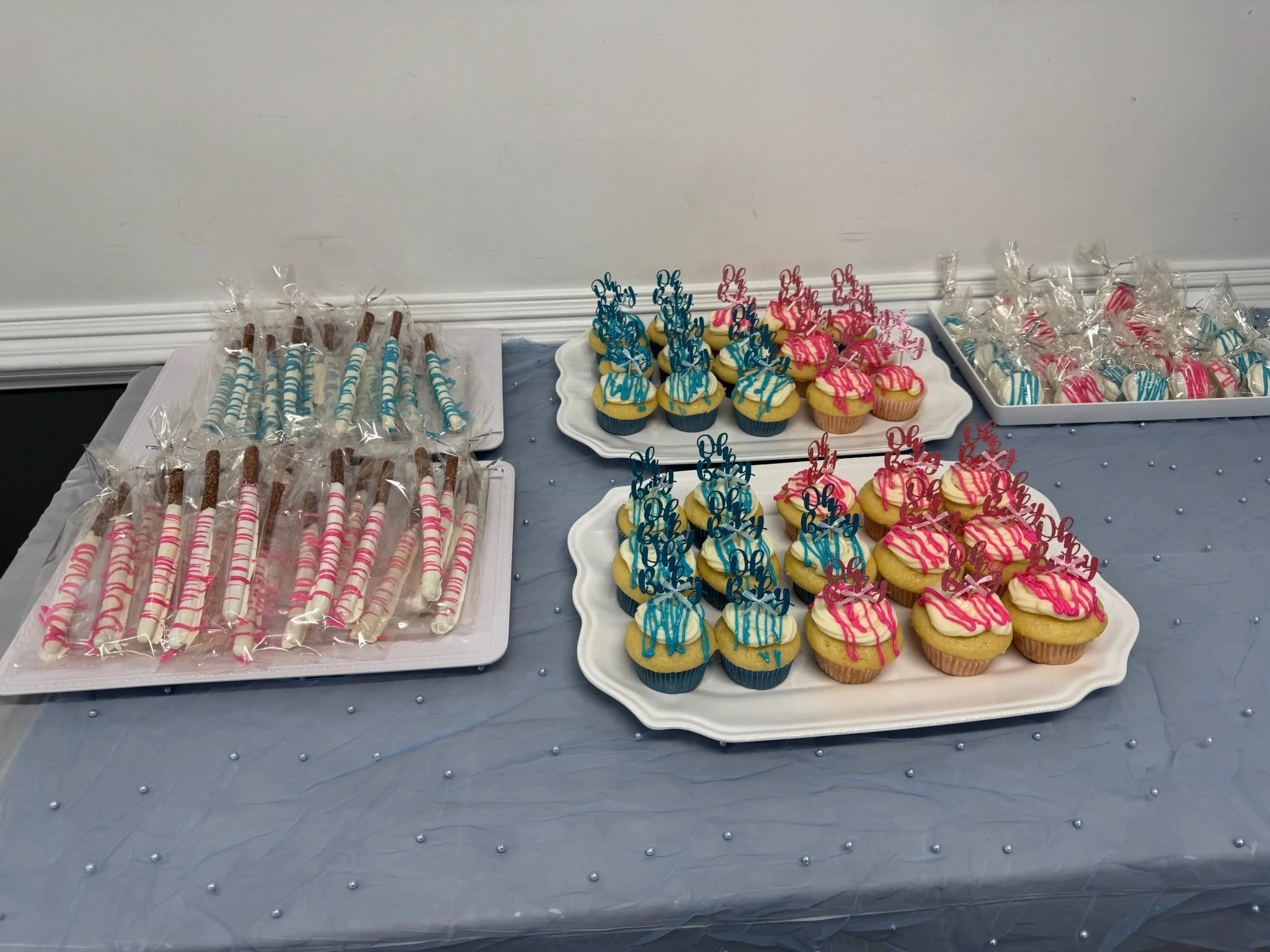 Table with school-themed cupcakes, cake pops, and wrapped candies for a celebration