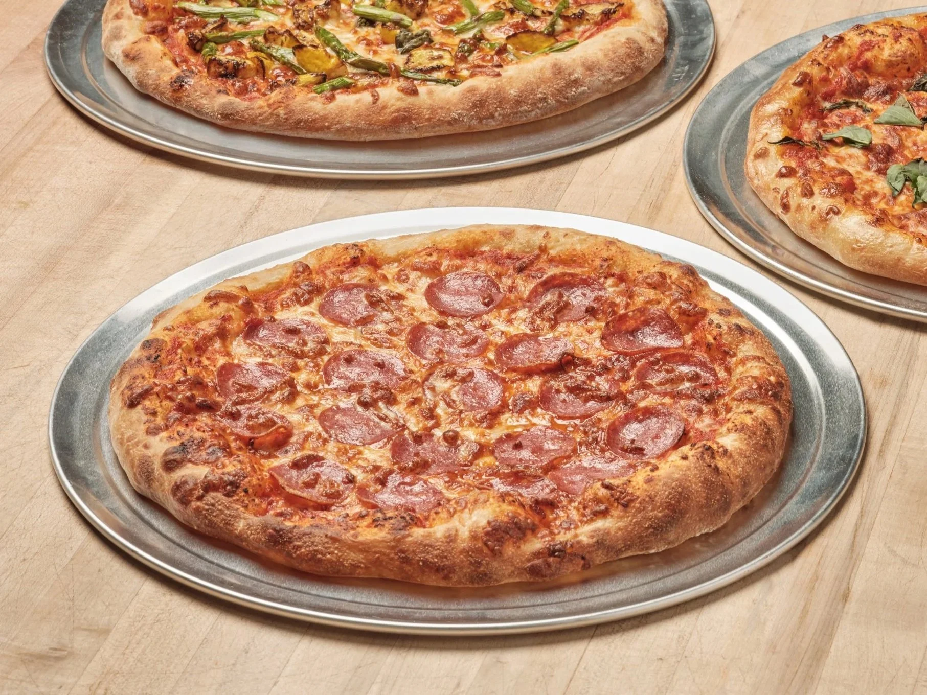 Pepperoni and vegetable pizzas made on Grand Central Bakery dough, supplied wholesale to Pacific Northwest pizzerias and restaurants