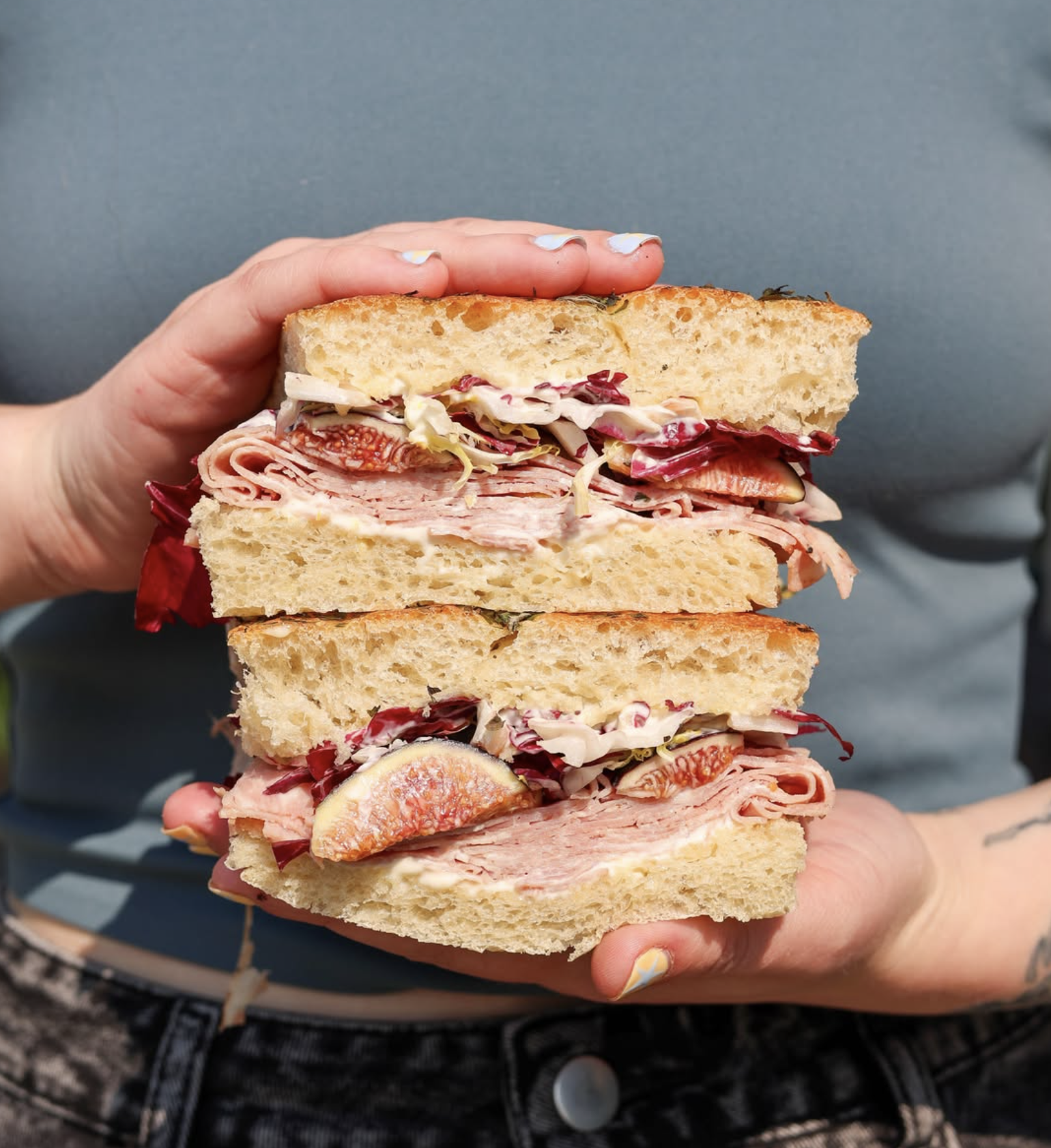 Layered deli sandwich on Grand Central Bakery artisan bread