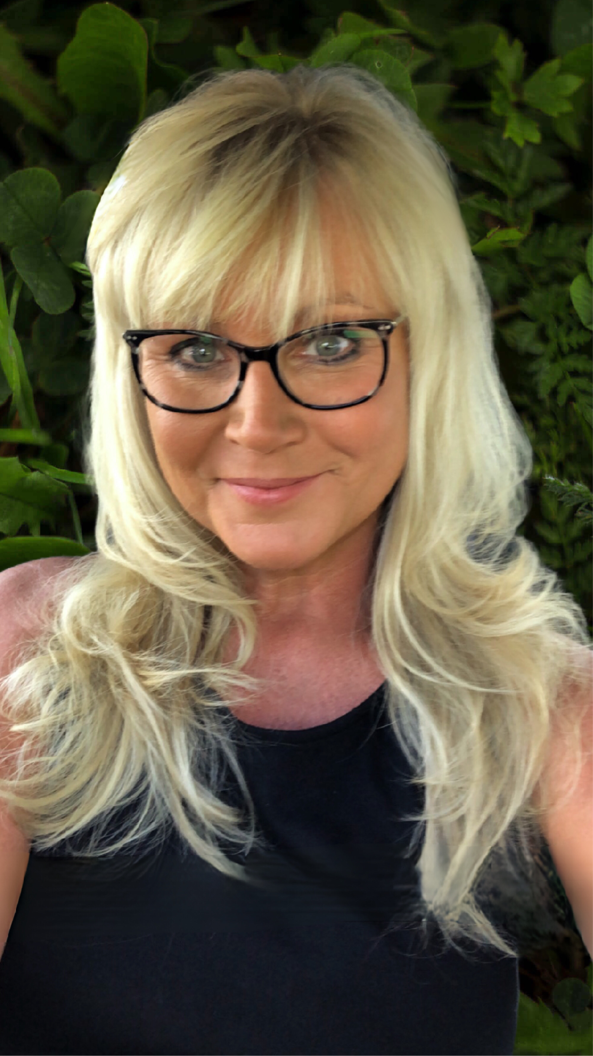 Heidi Headshot green leaf background 2023.png