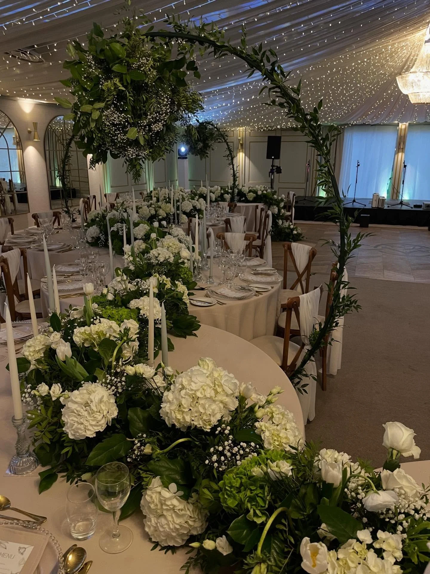 This time last year we were working on this stunning wedding for S&amp;R @beechhillcountryhouse . We styled the tables with a full length floral runner and coordinating candles. The finished look was elegant and magical. Overhead chandelier stands su