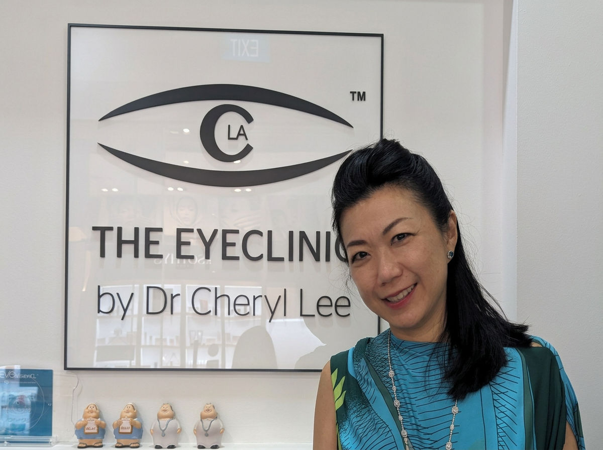 photo in front of The EyeCLinic by DR Cheryl Lee signage
