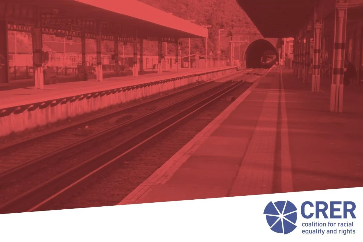 Picture of tracks and platform in a train station, tinted red