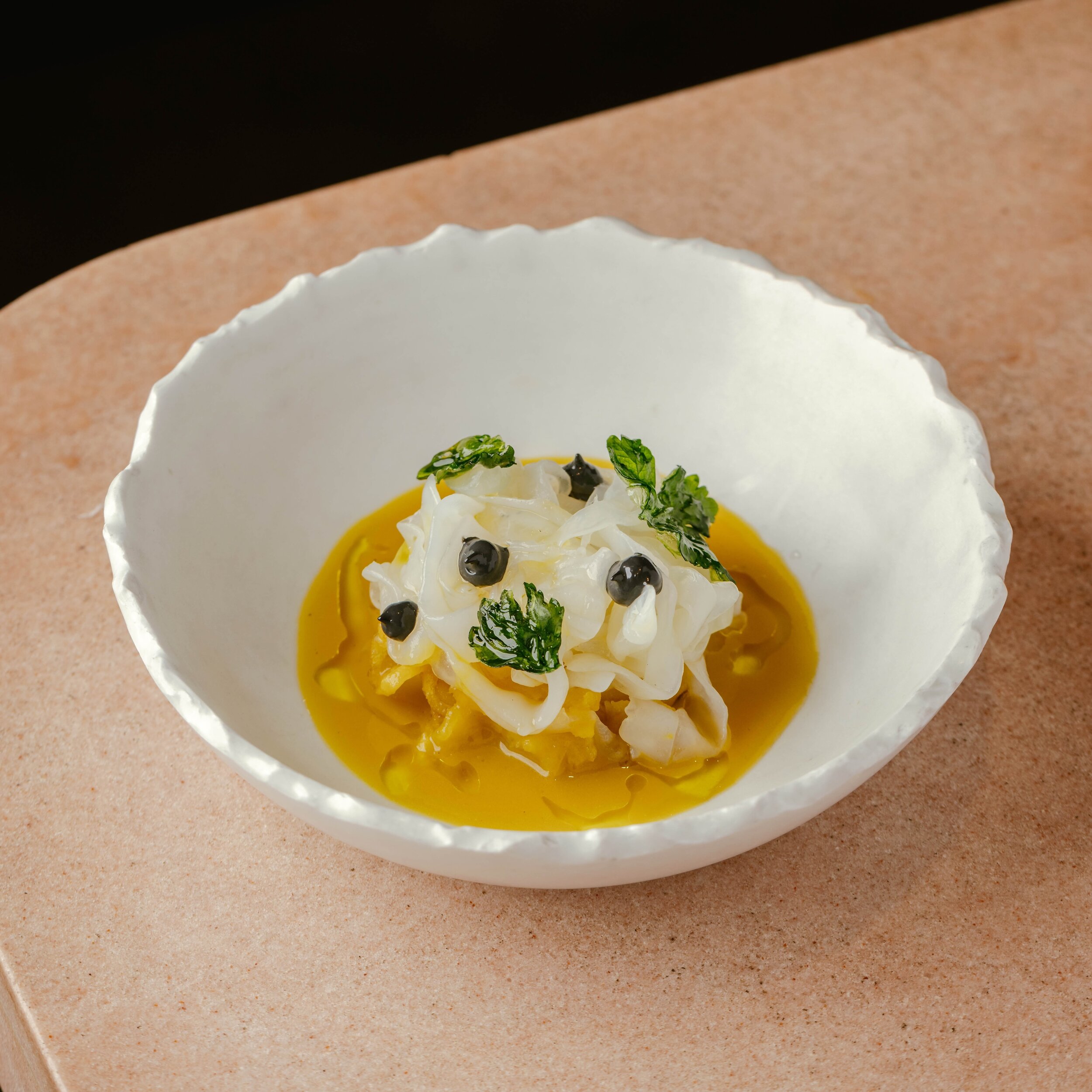 Prepare to be blown away by the incredible flavours of our Papas con Choco! This delight takes the traditional stew of cuttlefish and potato from the sunny south of Spain and elevates it to a whole new level. Picture tender confit cuttlefish tallarin