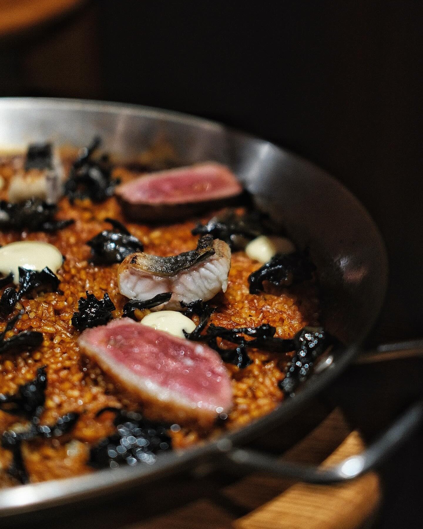 📸💫 Featuring a photo which captures the beauty of our delectable Duck and Eel Paella. It truly speaks volumes, showcasing the succulent Spanish duck breast, the smoky essence of grilled eel, the earthy delight of black trumpet mushrooms, and the fl