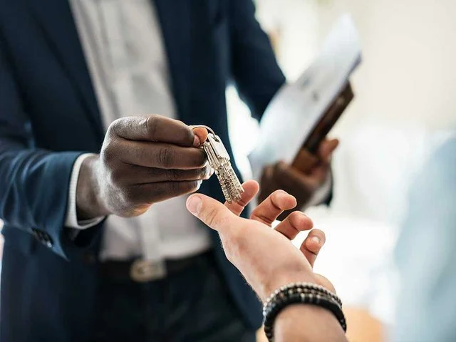 real-estate-agent-handing-over-keys.jpeg