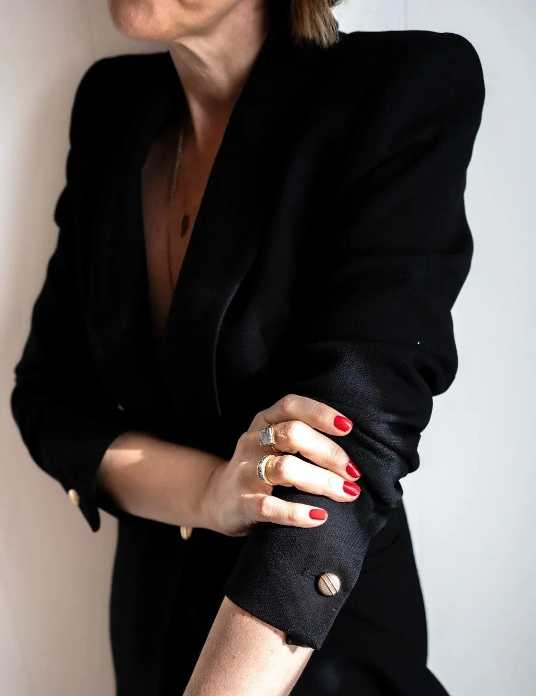 Founder lisa wearing a black blazer pushing up her sleeves