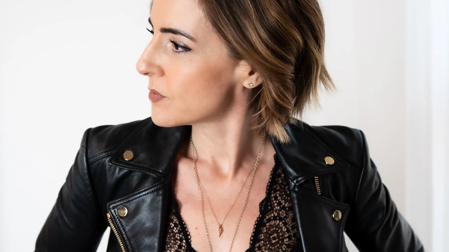 Lisa Moore, Sovereign Frequency Architect and Founder of House of Soul Sovereignty, in a black leather jacket