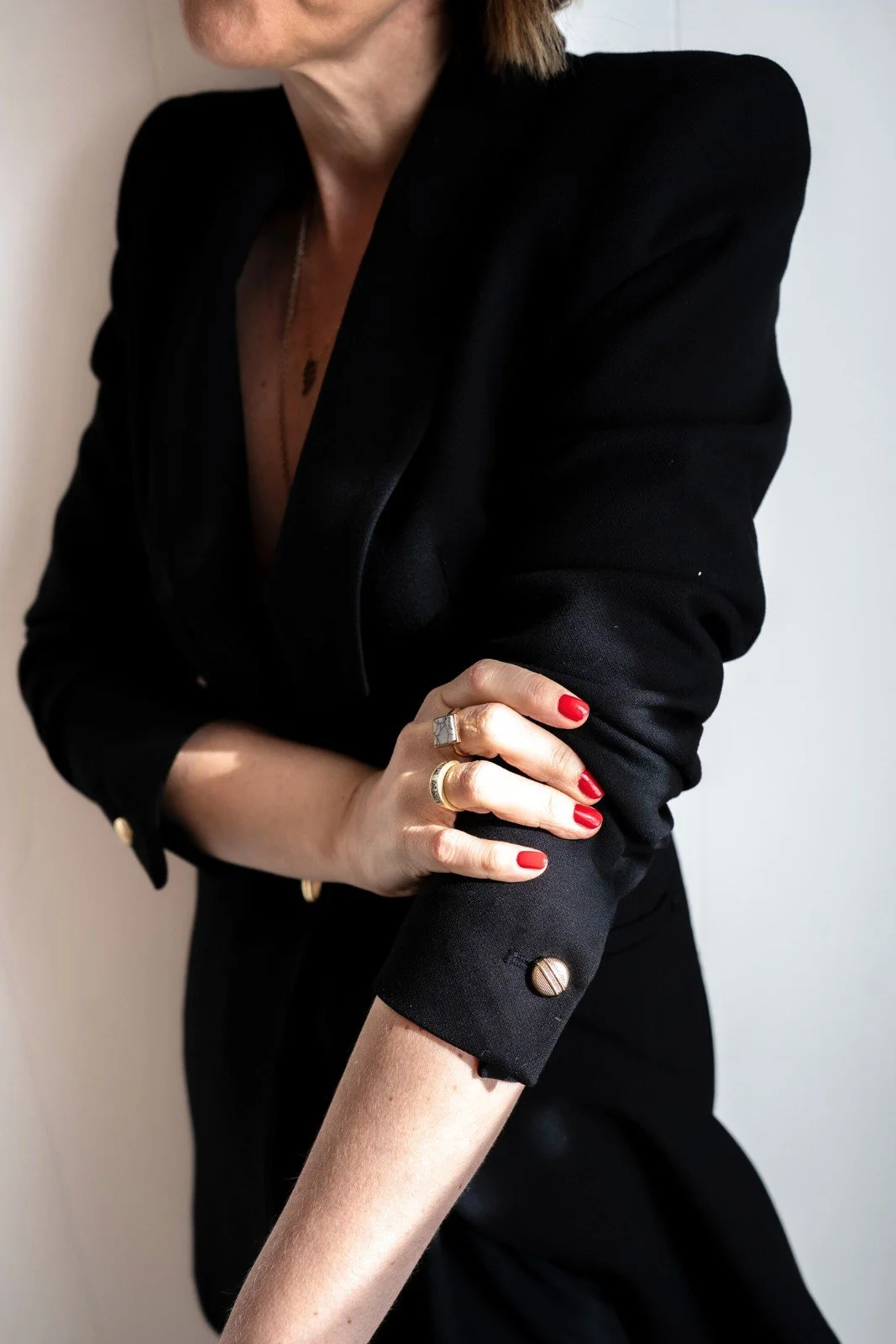 Lisa Moore, Sovereign Frequency Architect, in a black blazer with red nails and gold rings, embodying precise sovereign authority