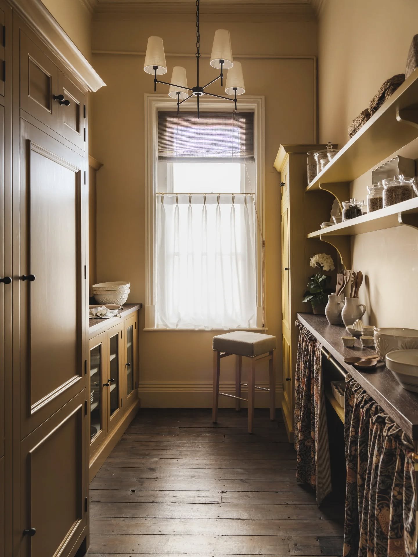 A pantry we rather wish we could quietly take home with us.

Bathed in a soft butter yellow, the room has a gentle warmth that feels settled and easy. Yellow isn't for everyone but this room is a testament to yellows done well, and an example of how 