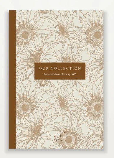 Cover of a collection book titled "Our Collection" for Autumn/Winter 2025 featuring a floral pattern with sunflowers and a brown vertical stripe on the left side.