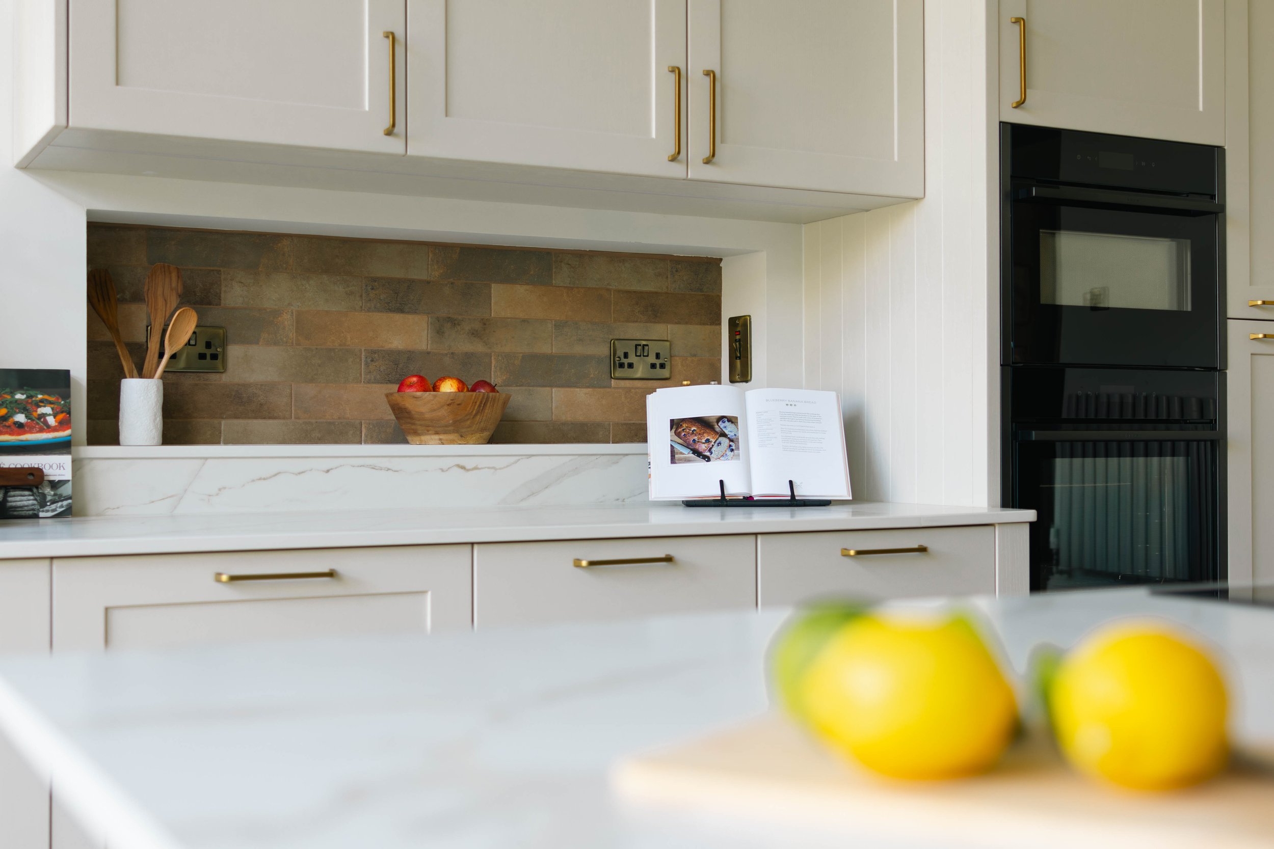 Traditional shaker kitchen with rattan, brass accents and Dekton stone
