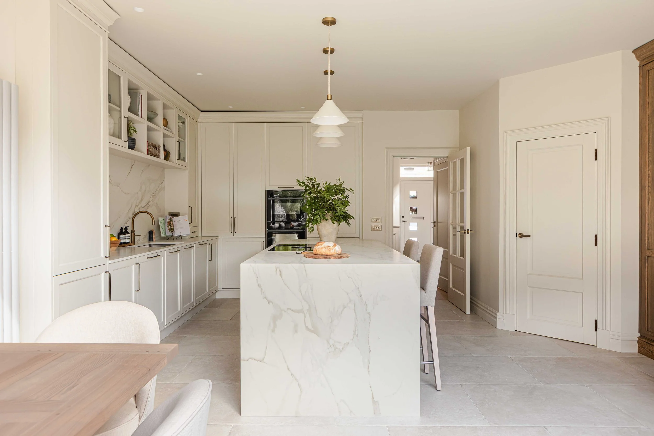 Neutral shaker kitchen with waterfall island. Heathfield island pendants