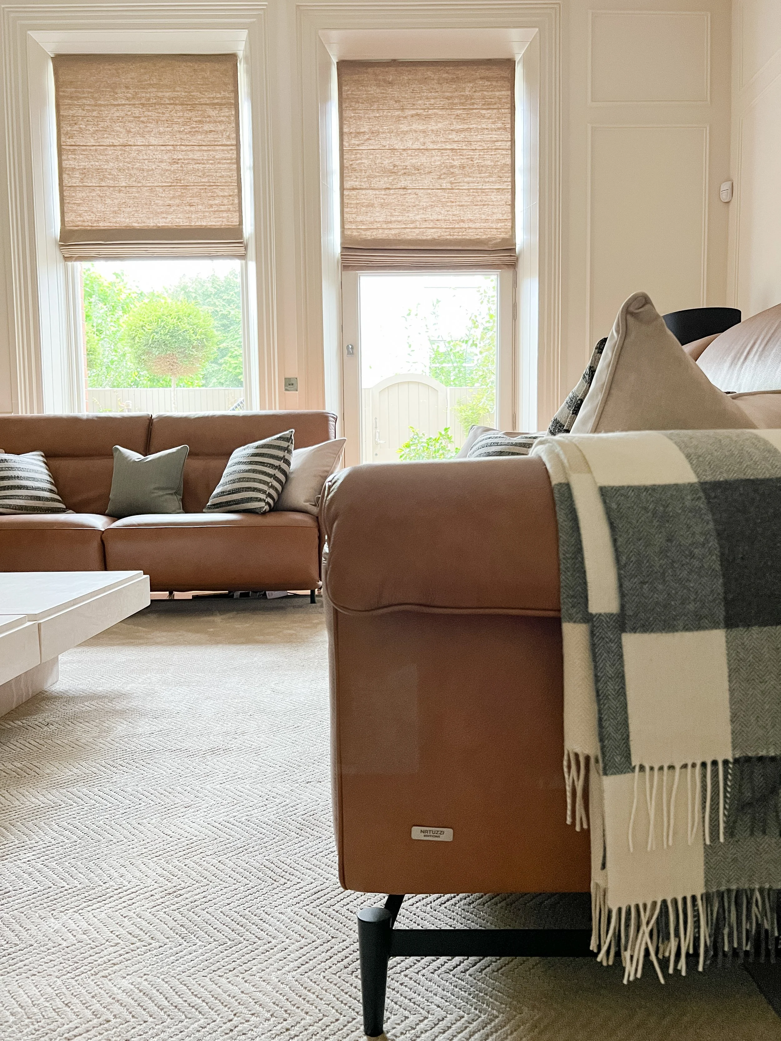 Tan leather sofas and custom rug