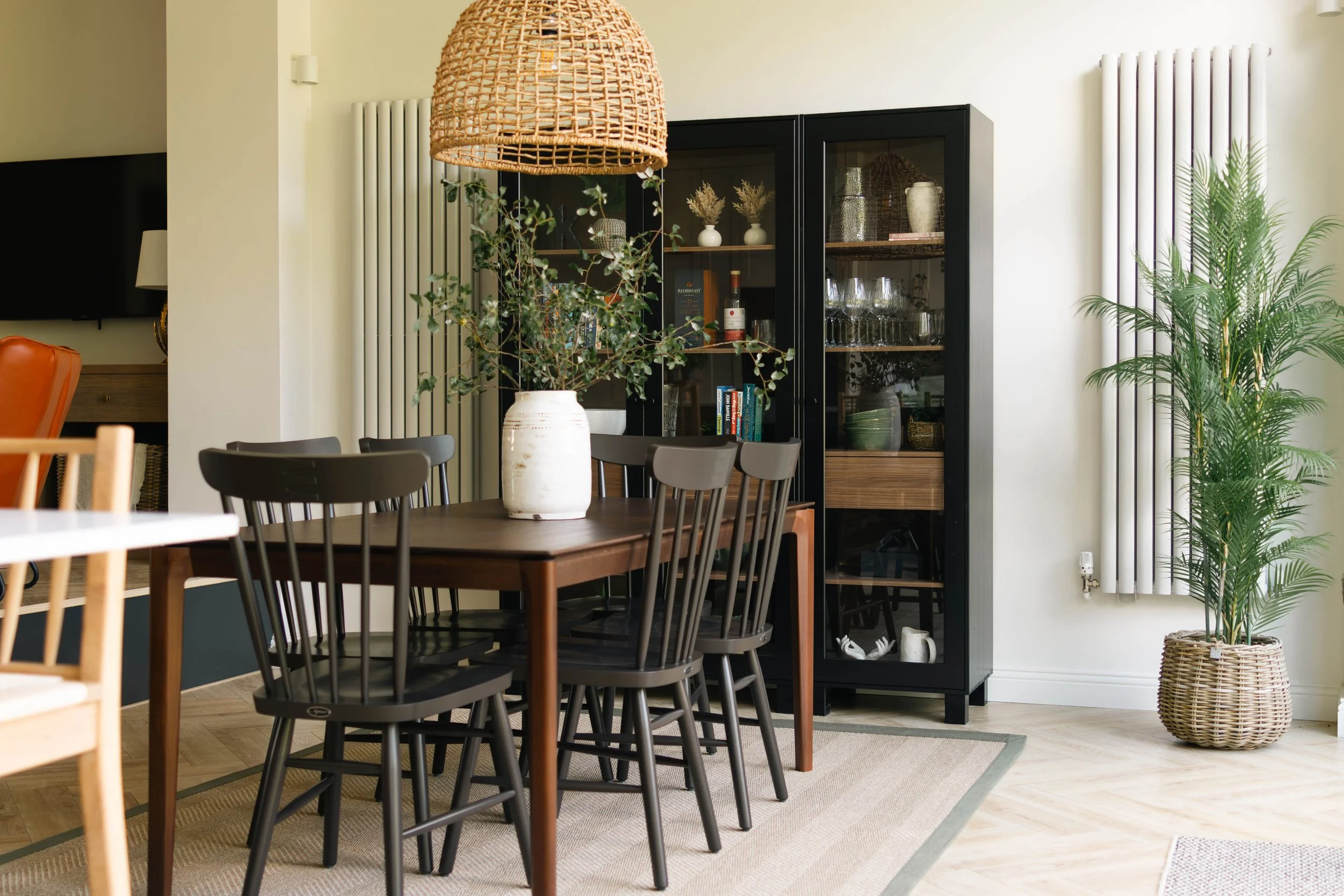 Classic country Neptune dining chairs with Ethnicraft Bok table and glass cabinet, rattan pendant
