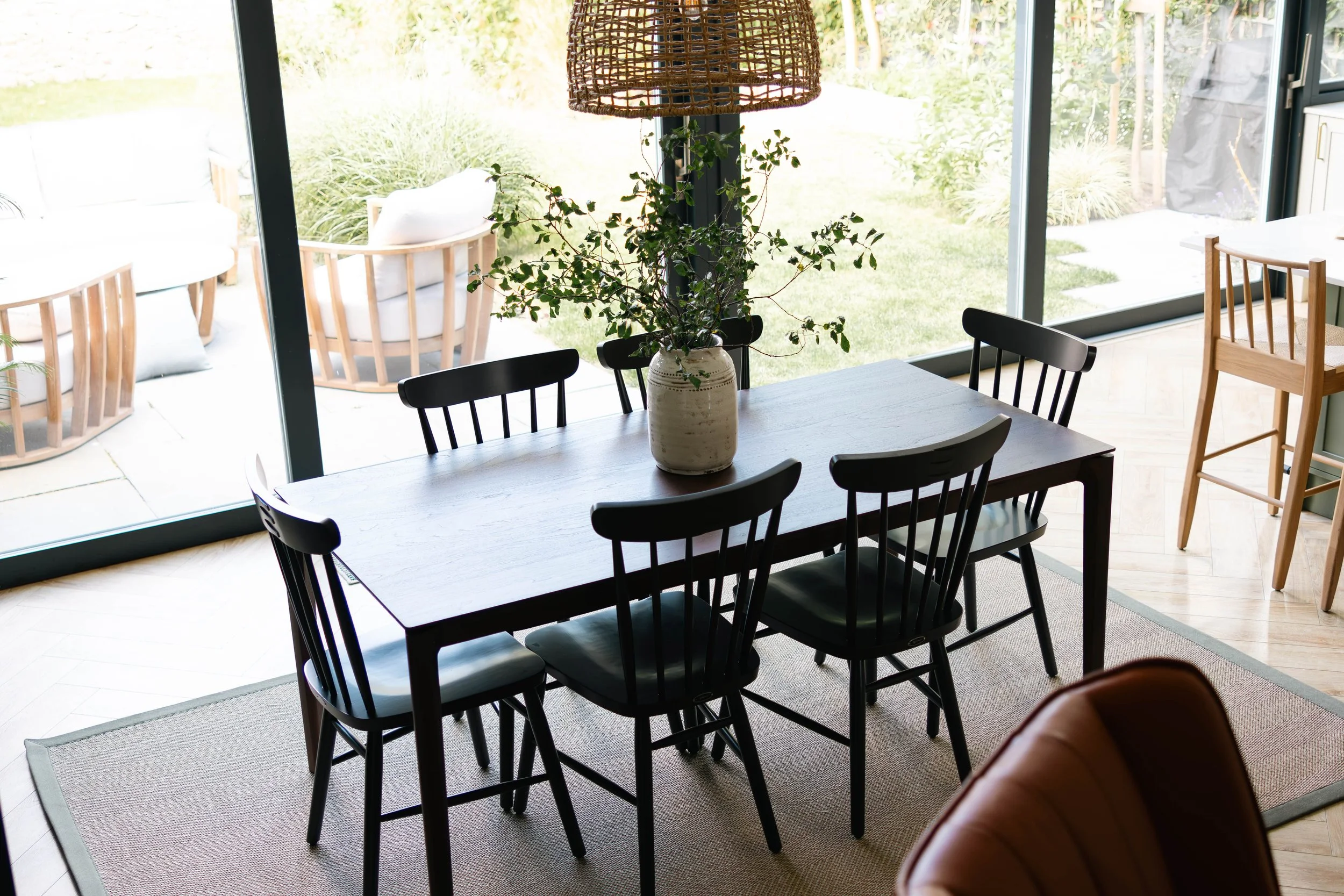 Classic country Neptune dining chairs with Ethnicraft Bok table and glass cabinet, rattan pendant