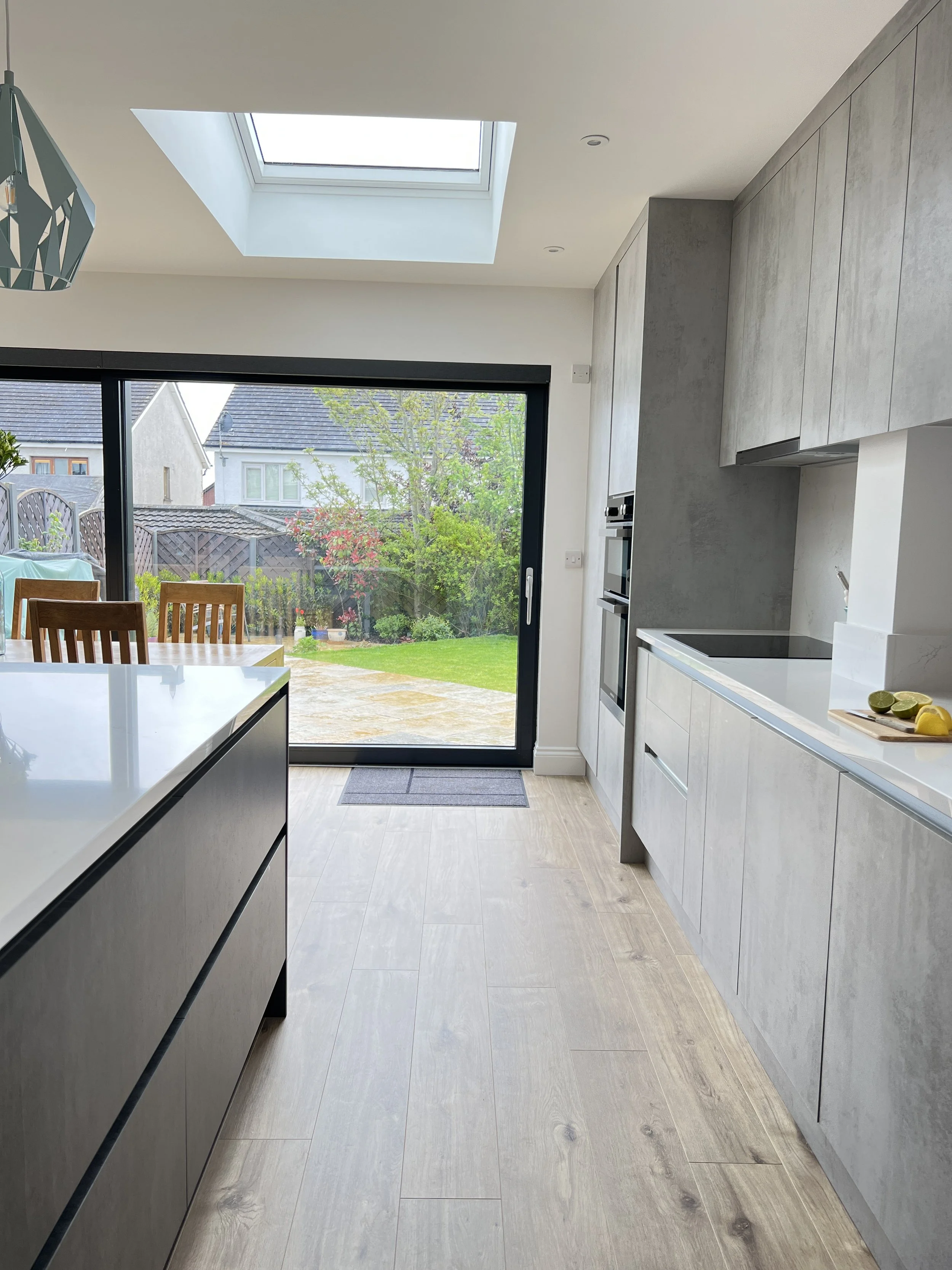Grey kitchen with black sliding door to patio