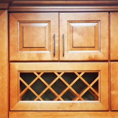 Wooden kitchen cabinet with two upper doors and a built-in wine rack in the center.