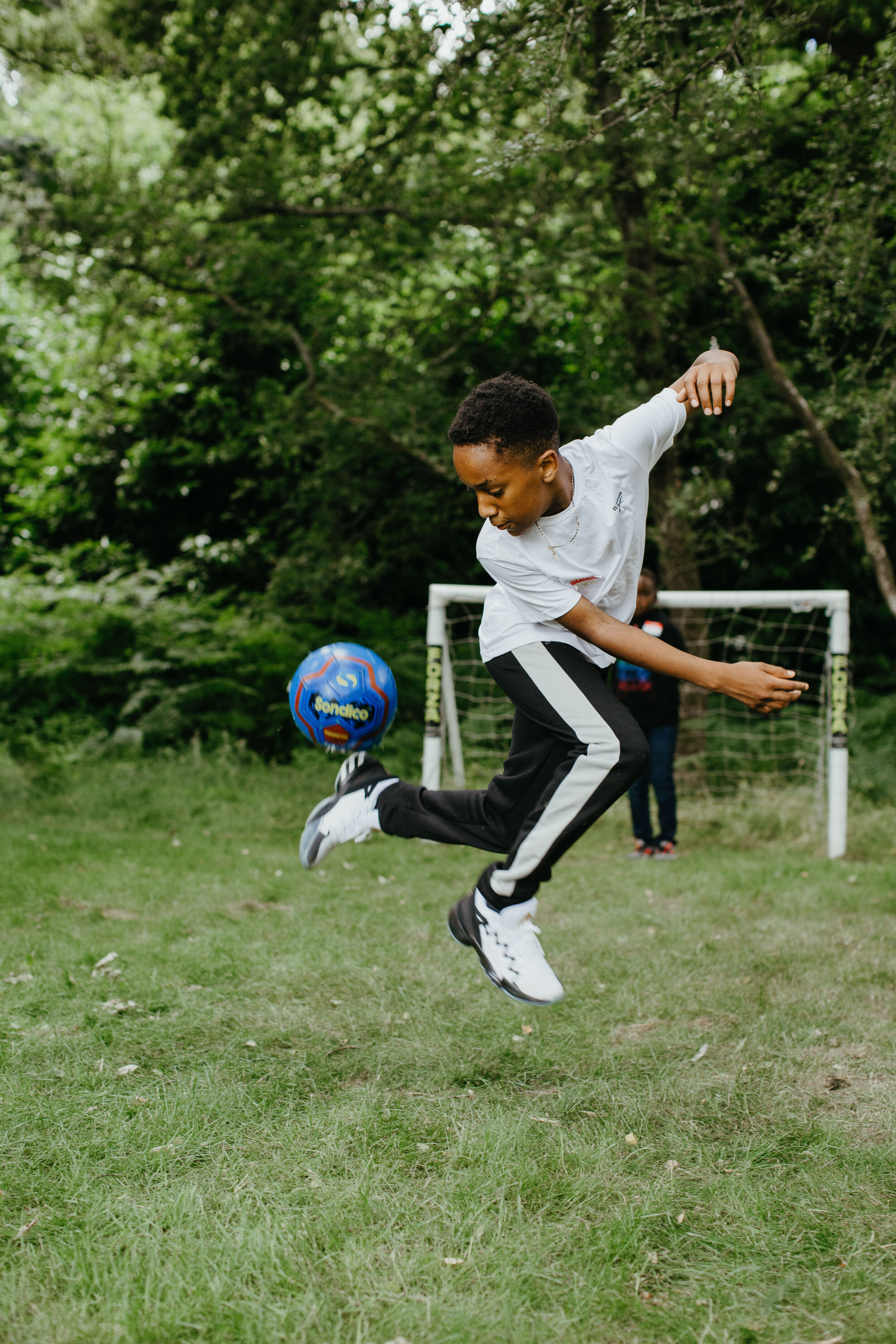 Boy in white t-shirt doing a rainbow flick.
