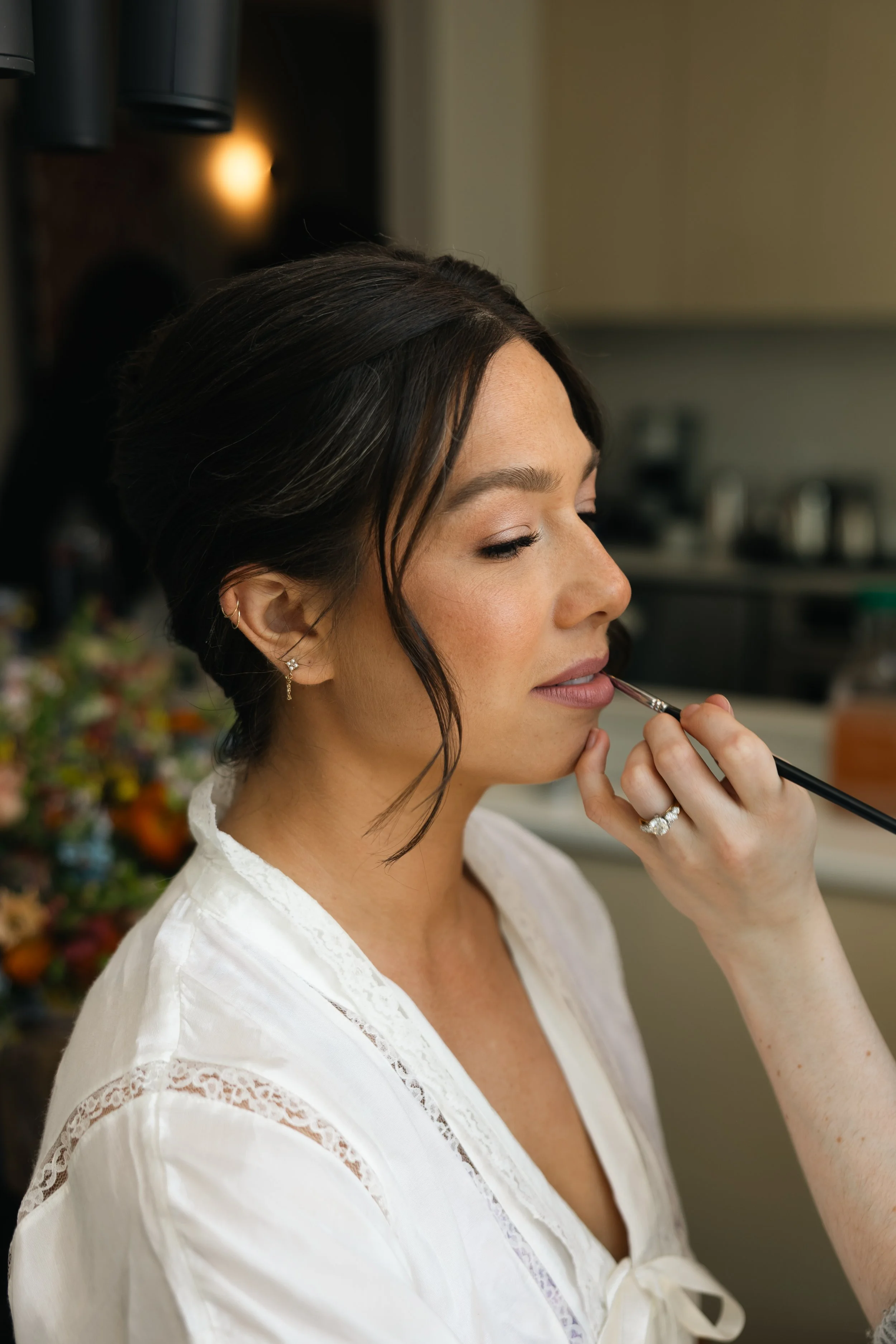 makeup artist applying lipstick