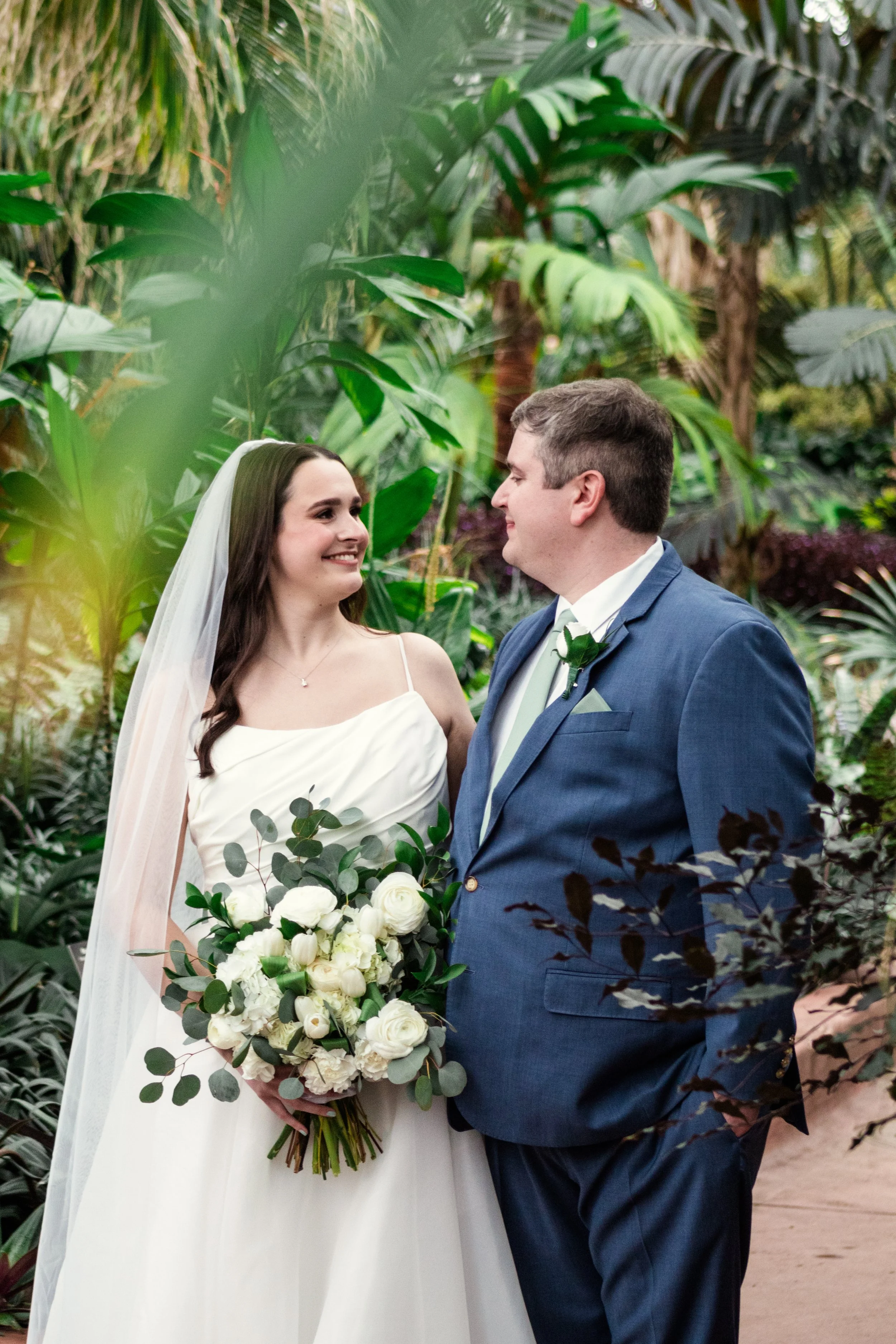 bride and groom with greenery