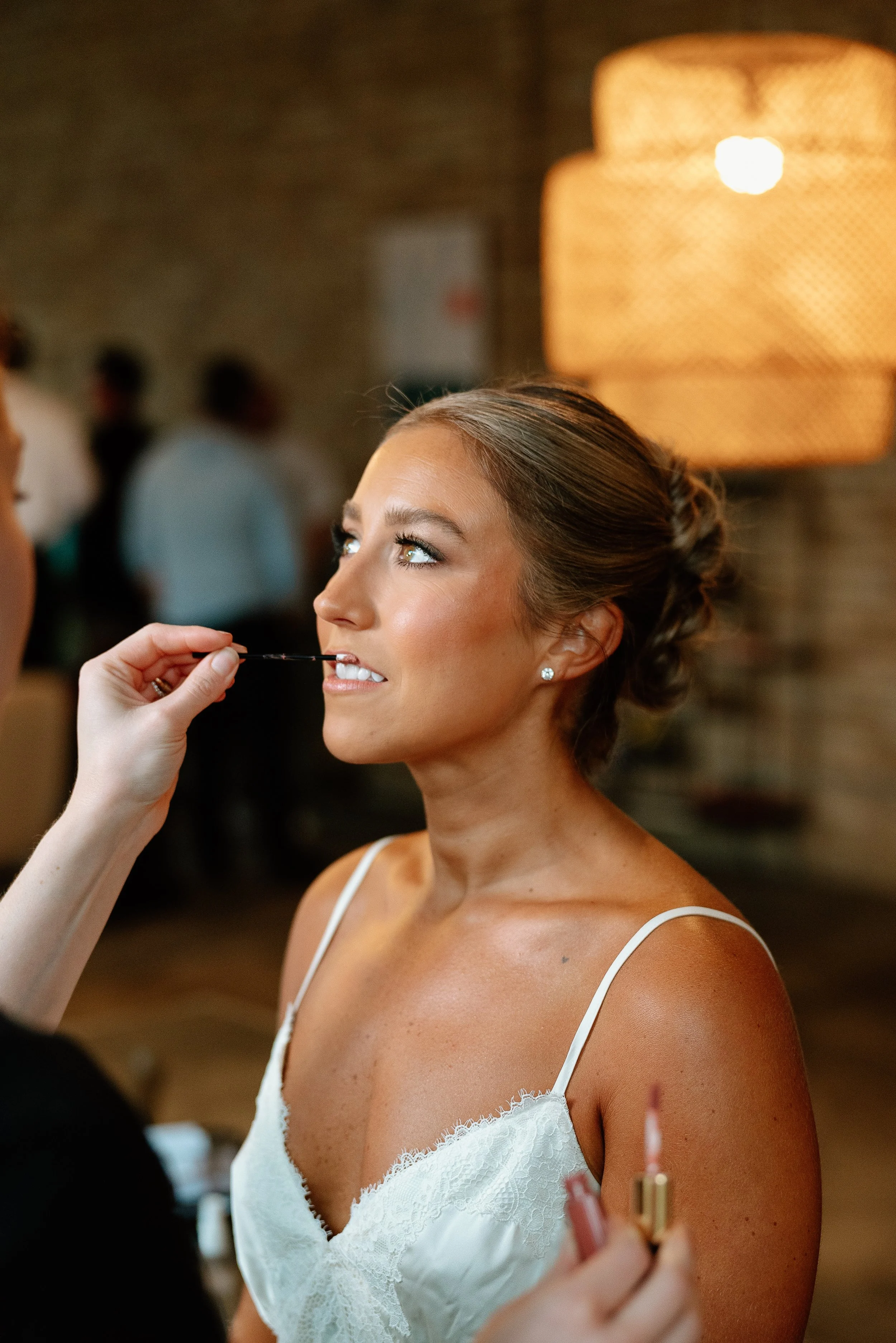 bride getting lipstick applied