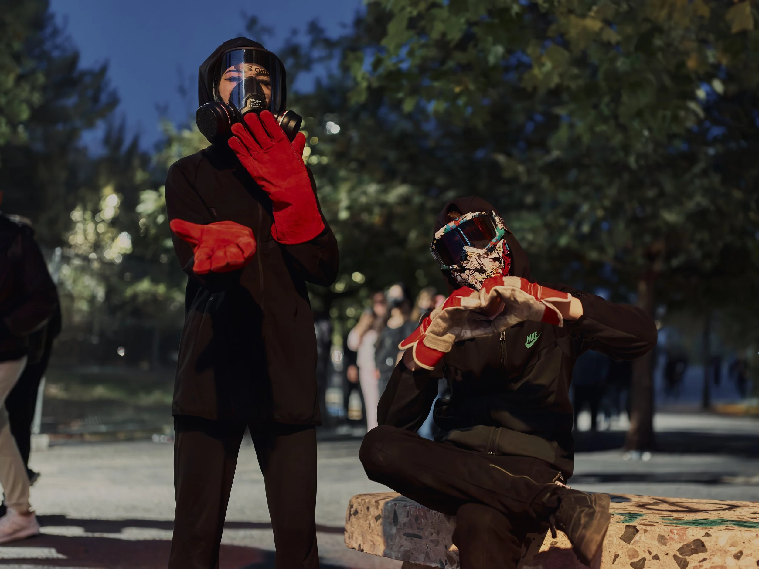 Two widely recognised demonstrators form heart shapes with their hands, conveying a message of love and solidarity.