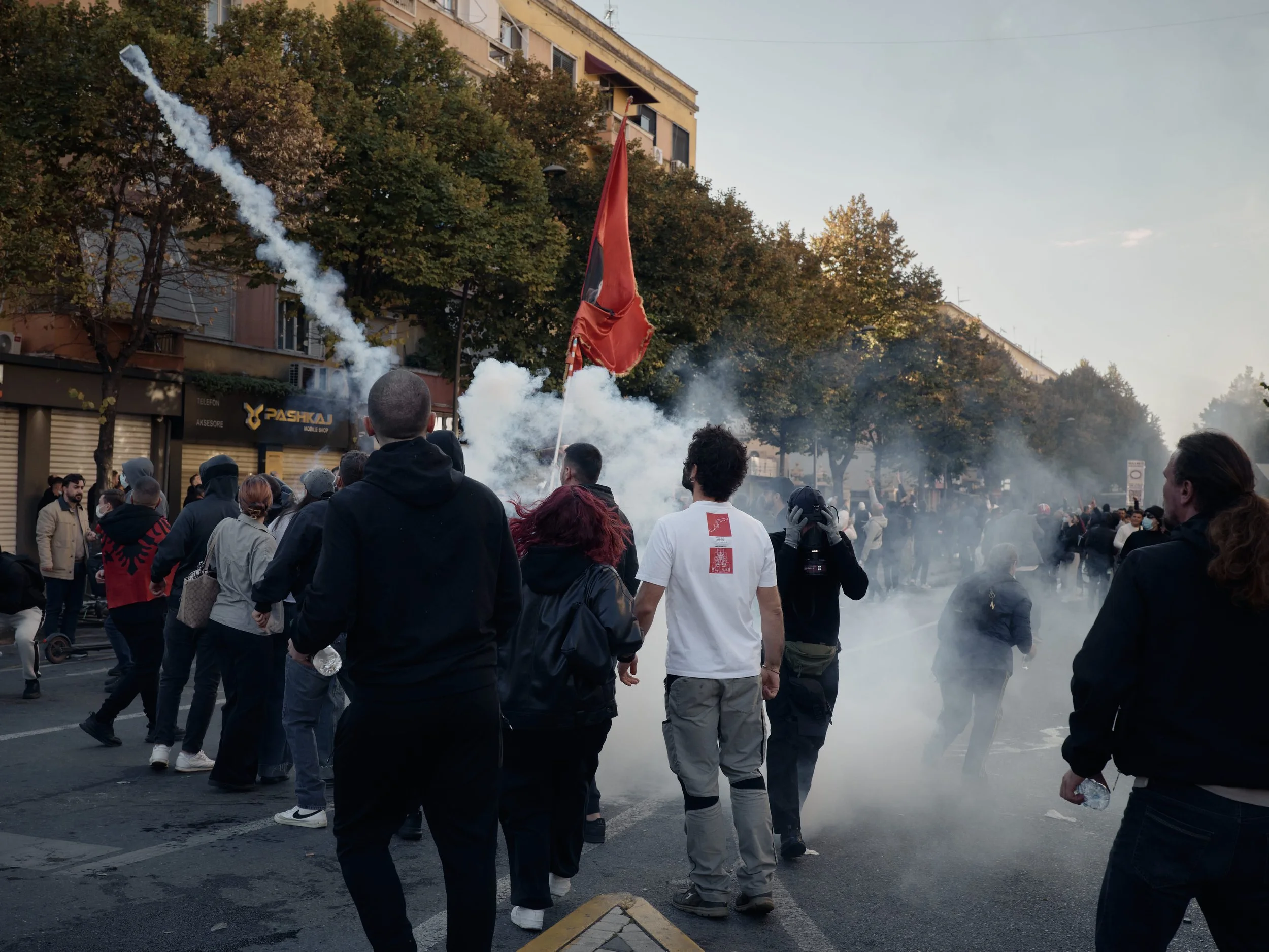Students remove a tear gas canister from the crowd and throw it away from the demonstrators.