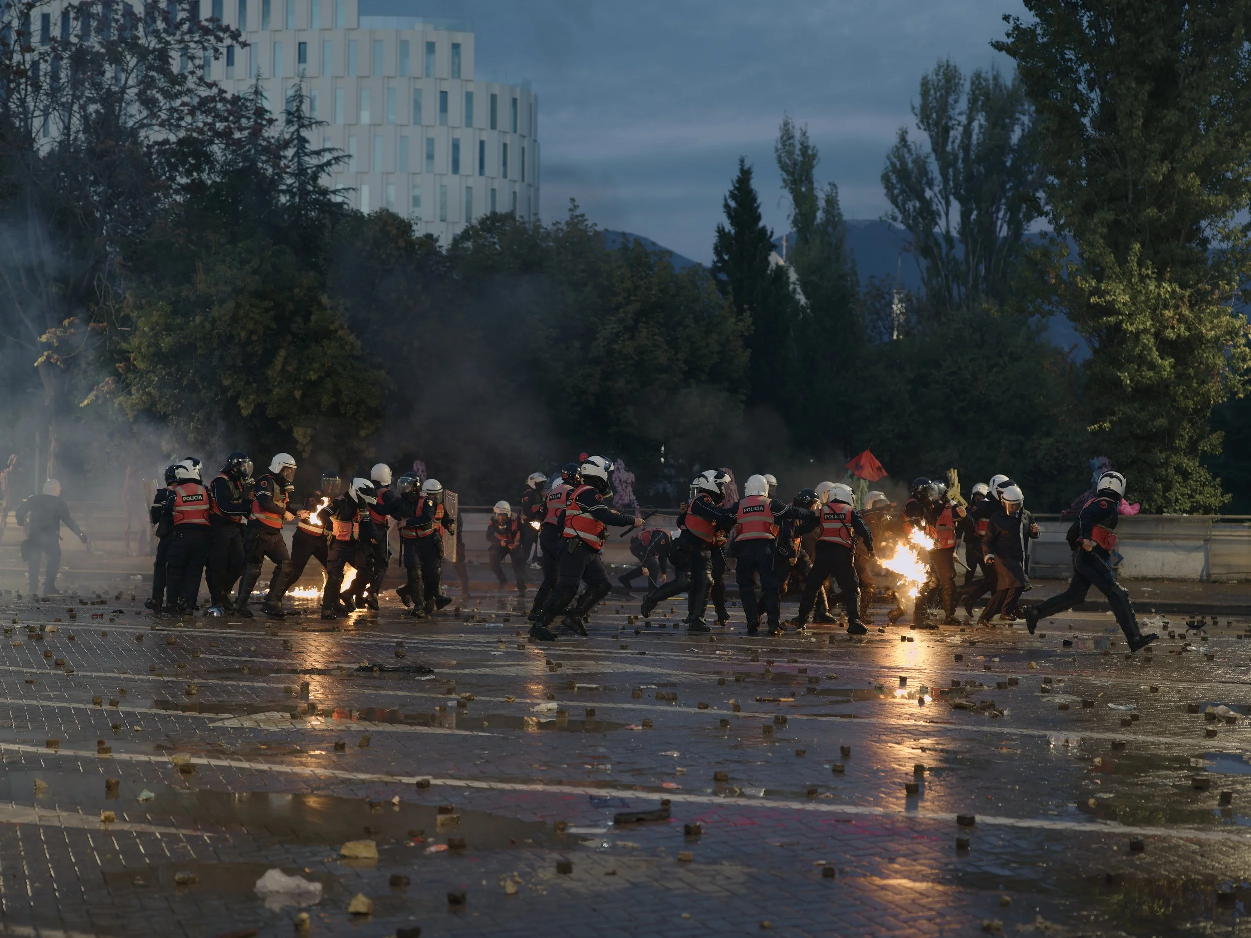 Two police officers are engulfed in flames moments after demonstrators throw a Molotov cocktail towards them.