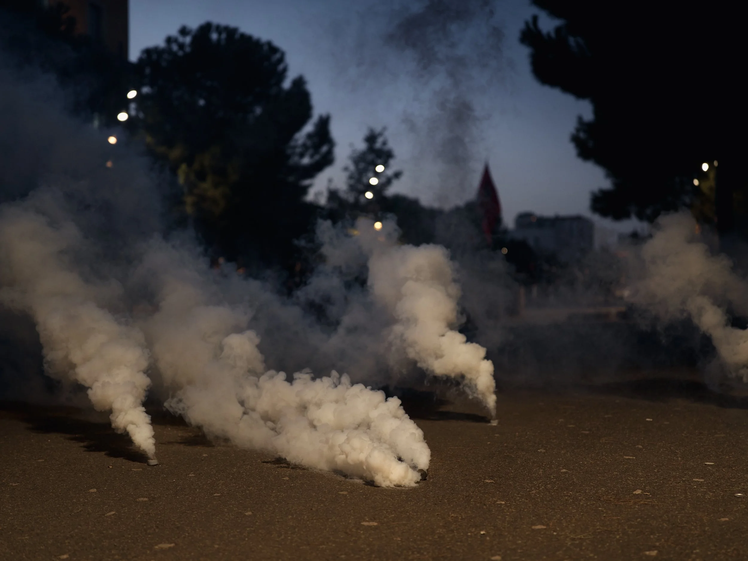 Tear gas fills the area in front of the Ministry of Internal Affairs as police attempt to disperse the crowd.