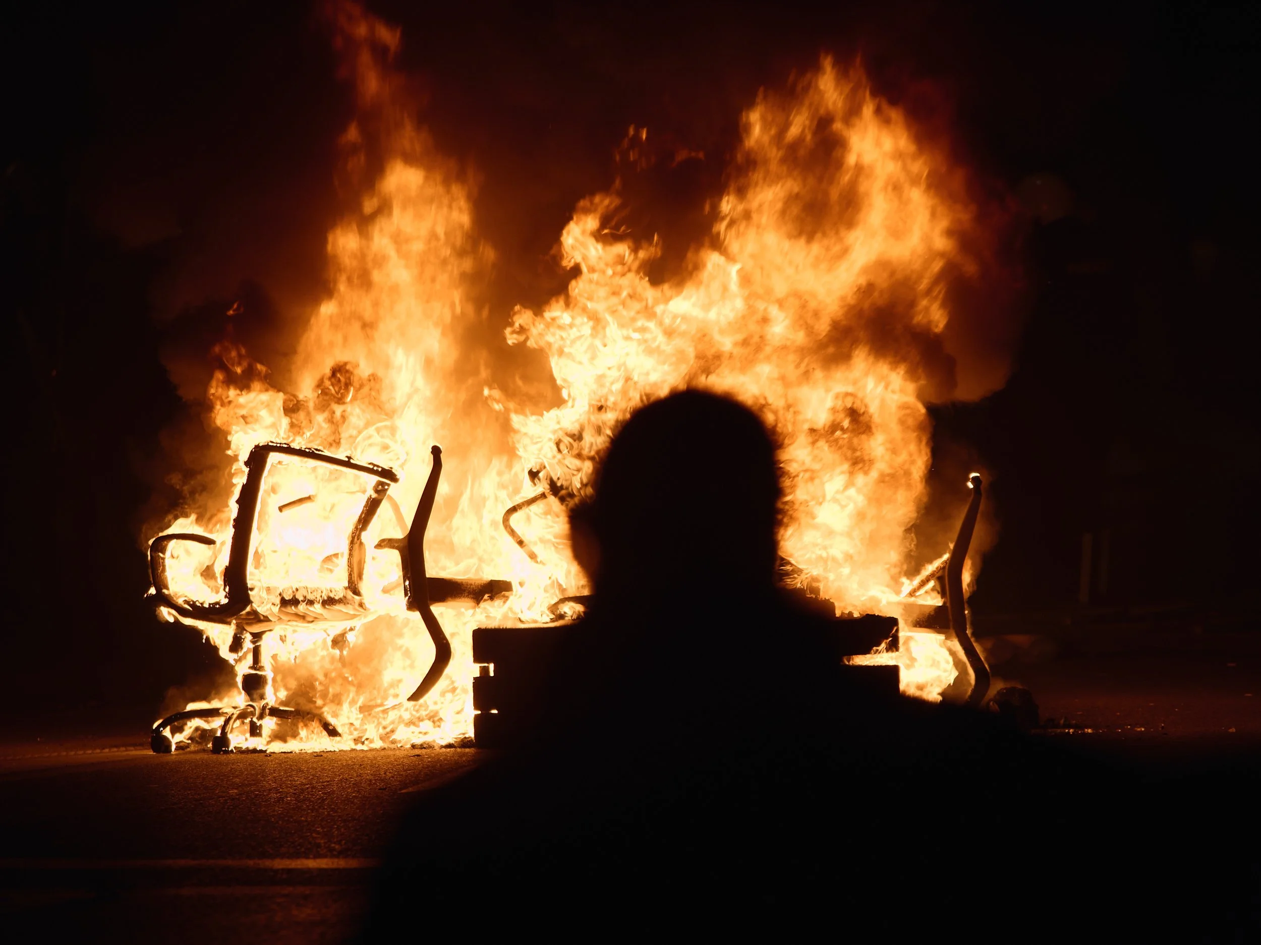 Chairs burn during the protests. Some demonstrators use the burning chairs as a symbol of their demand for politicians to resign, accusing them of prioritising their positions over the public interest.