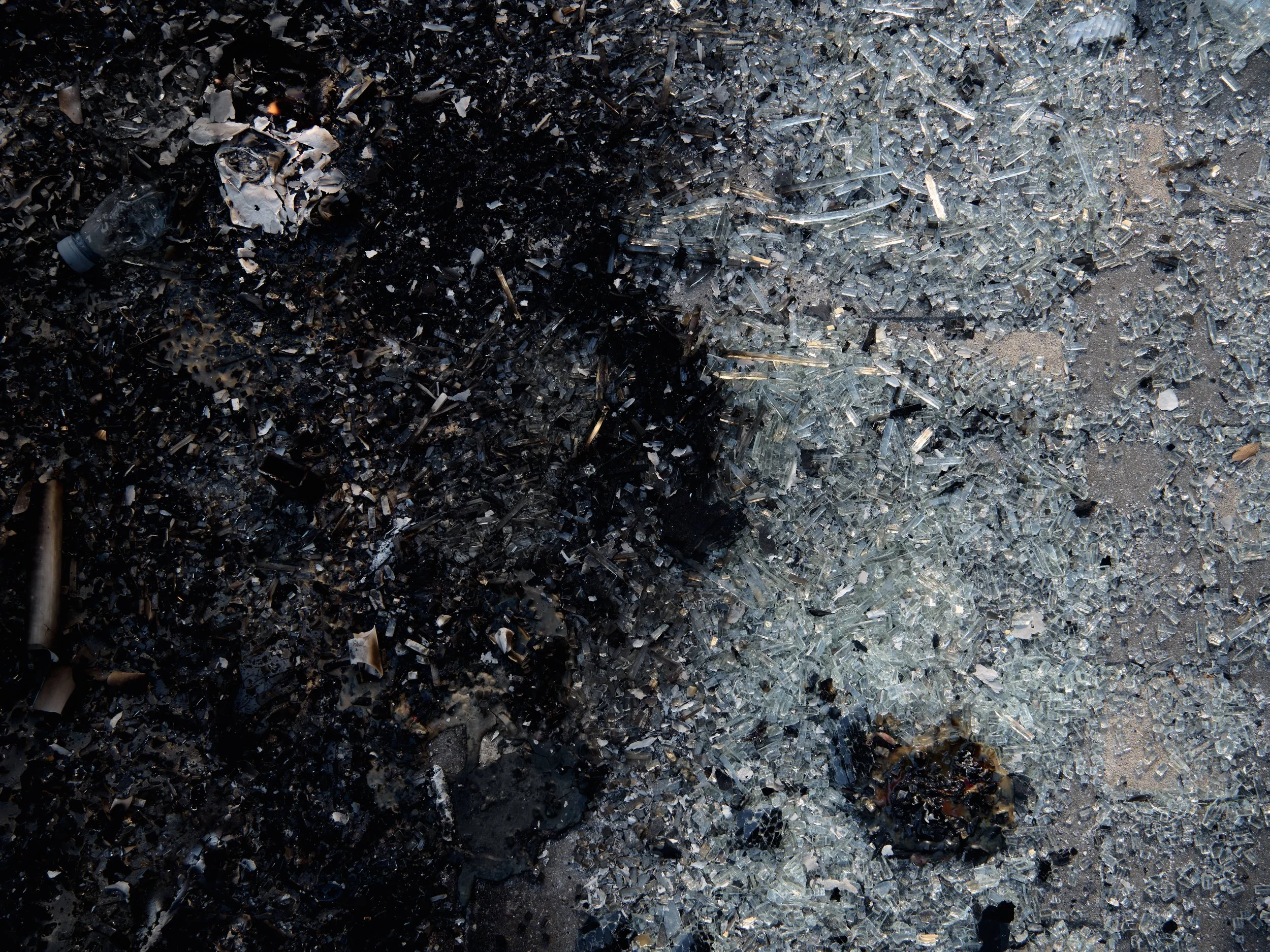 The remains of the first streetlight set on fire during the protest.