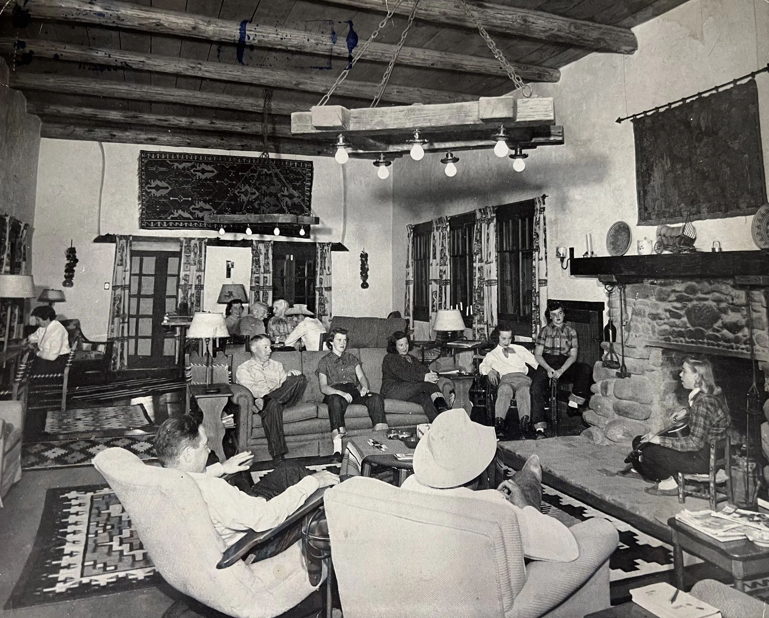 A 1950s postcard. The living room of the main lodge is beamed with the original telegraph poles that ran between Wickenburg and Phoenix. The cross ties from those poles were used to make the living room hanging chandeliers.