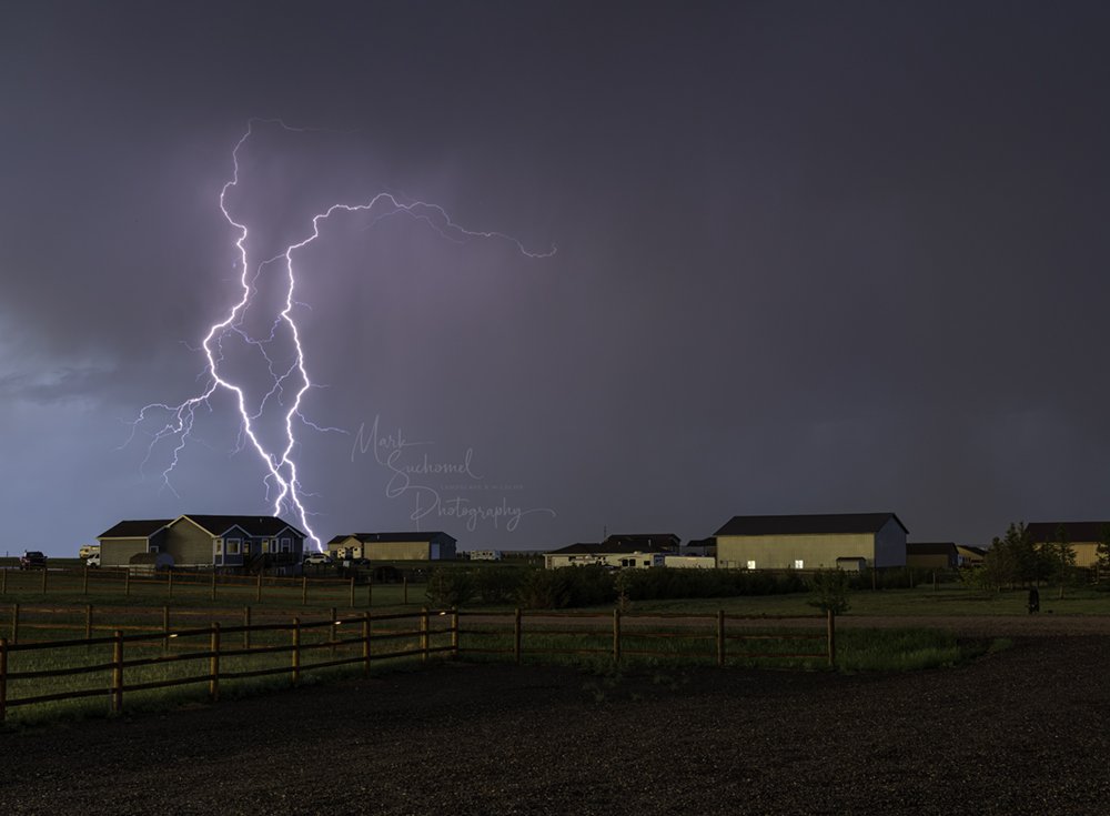 Cheyenne, Wyoming, a late afternoon thunderstorm moving over a residential neighborhood with multiple lightning strike 