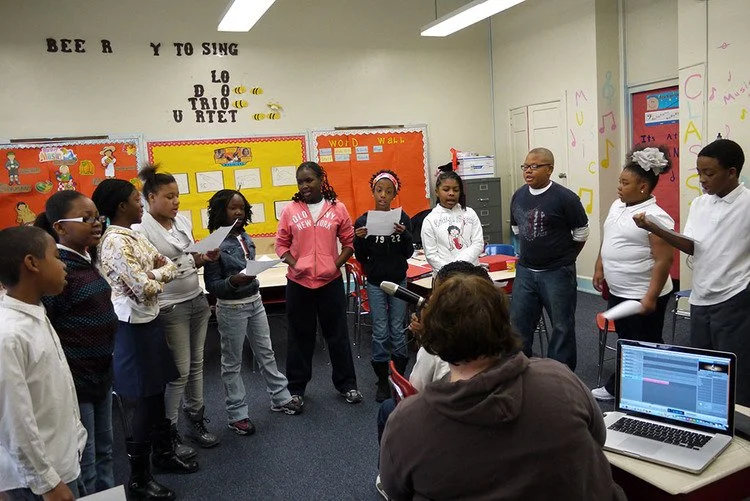 group of students dance in a circle
