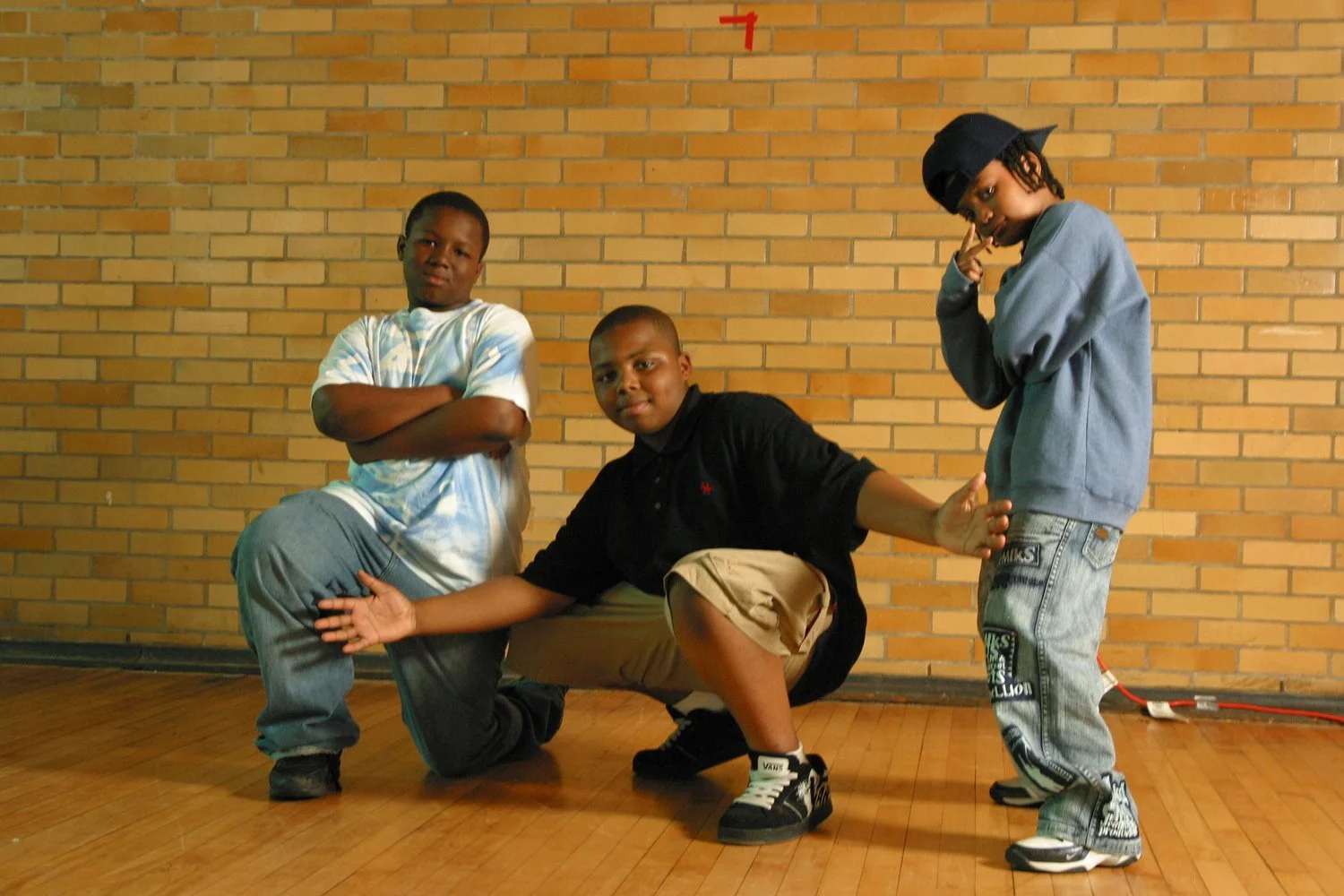 three young boys posing on stage