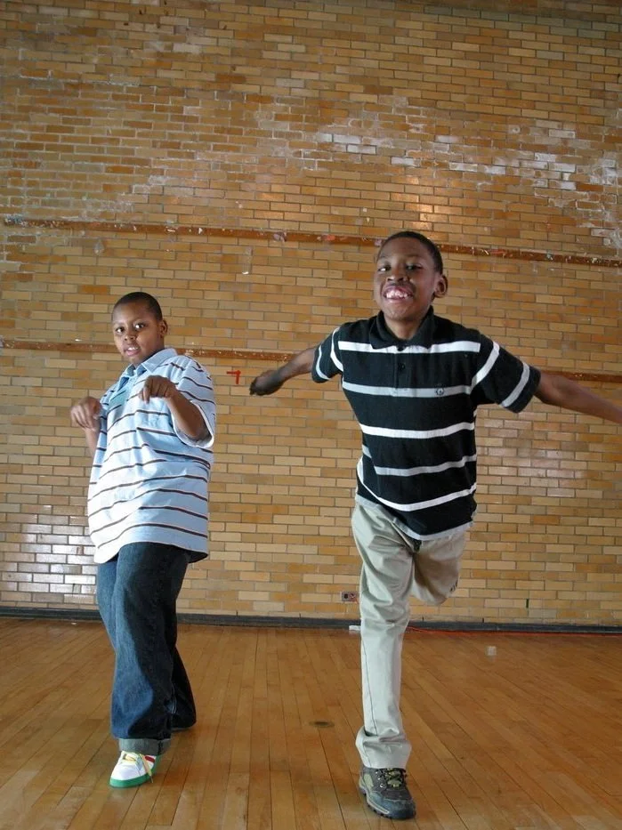 two young boys dancing on stage