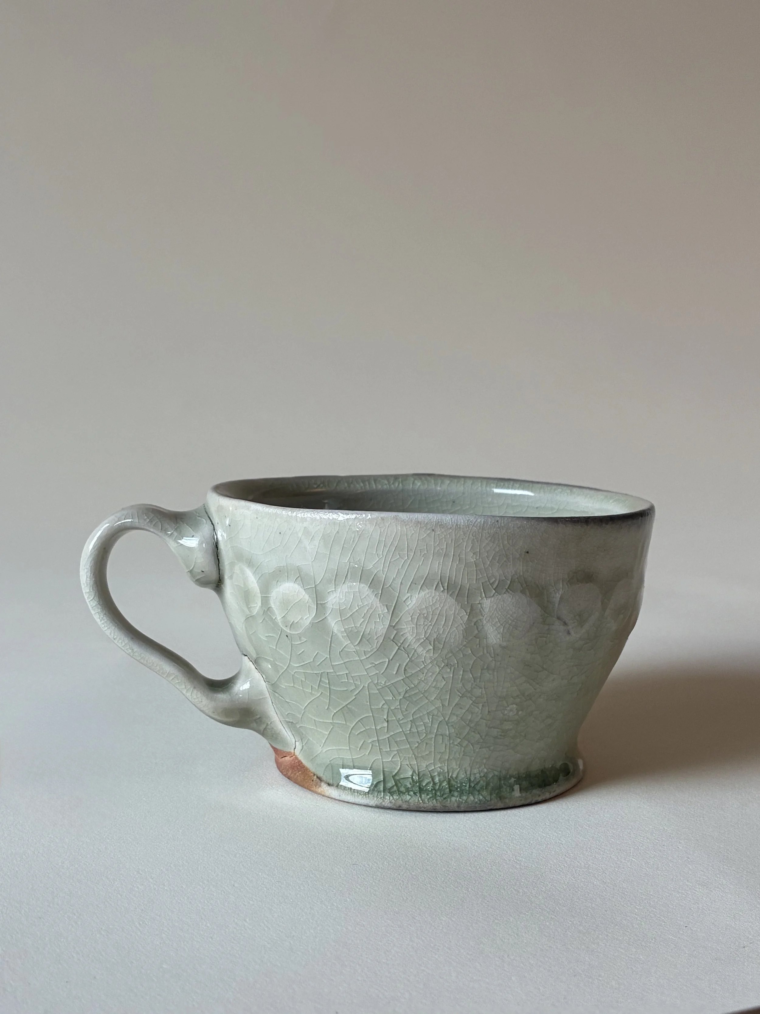 Mug with water-etched pattern and celadon glaze