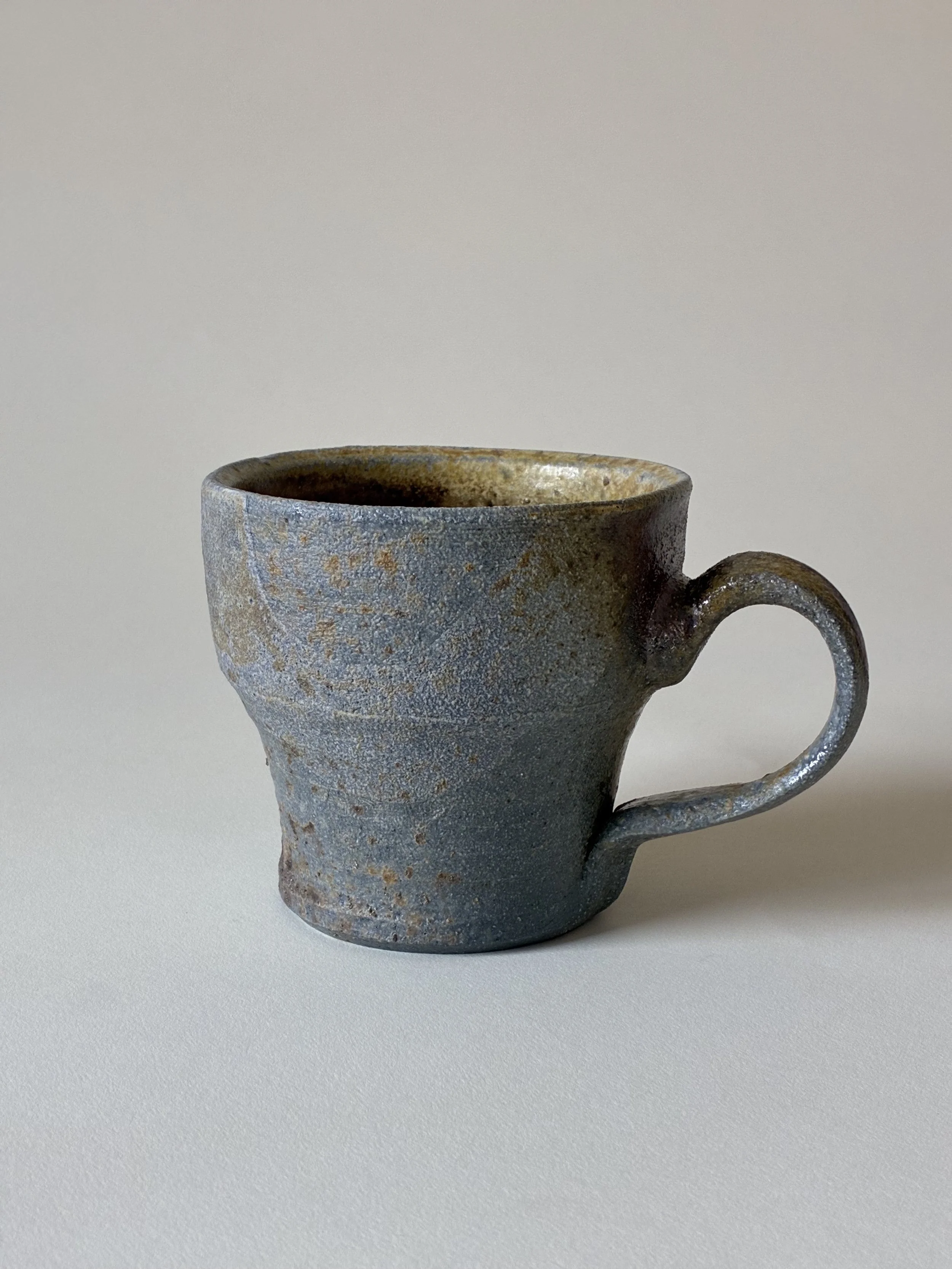 Stoneware mug with porcelain slip decoration