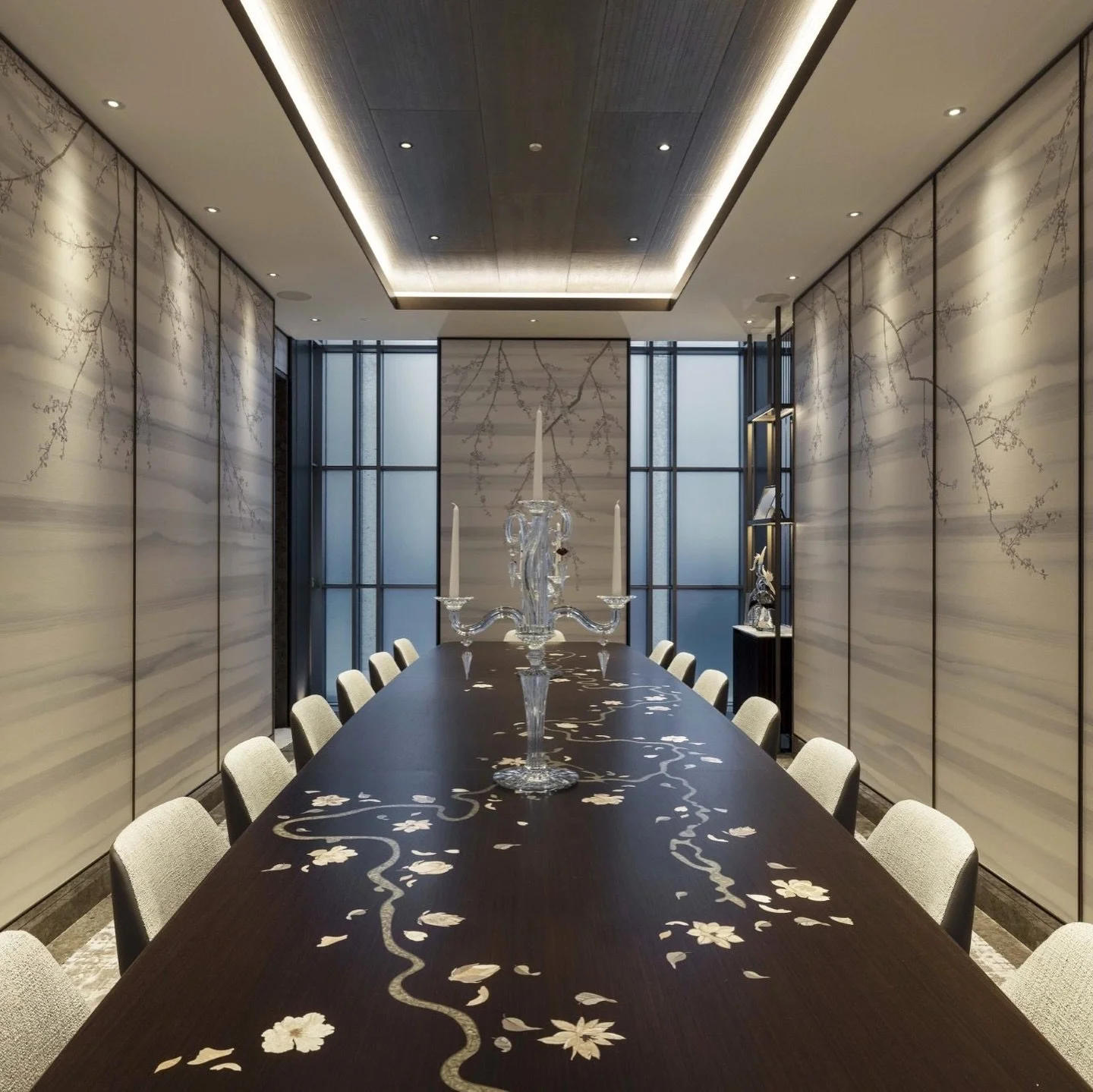 A bespoke five metre long dining table. The table top features marquetry magnolia blossom and a hand carved metal resin river that meanders down the table. The base is finished in a polished metal that is totally bespoke to Rigby &amp; Rigby. 
The fl