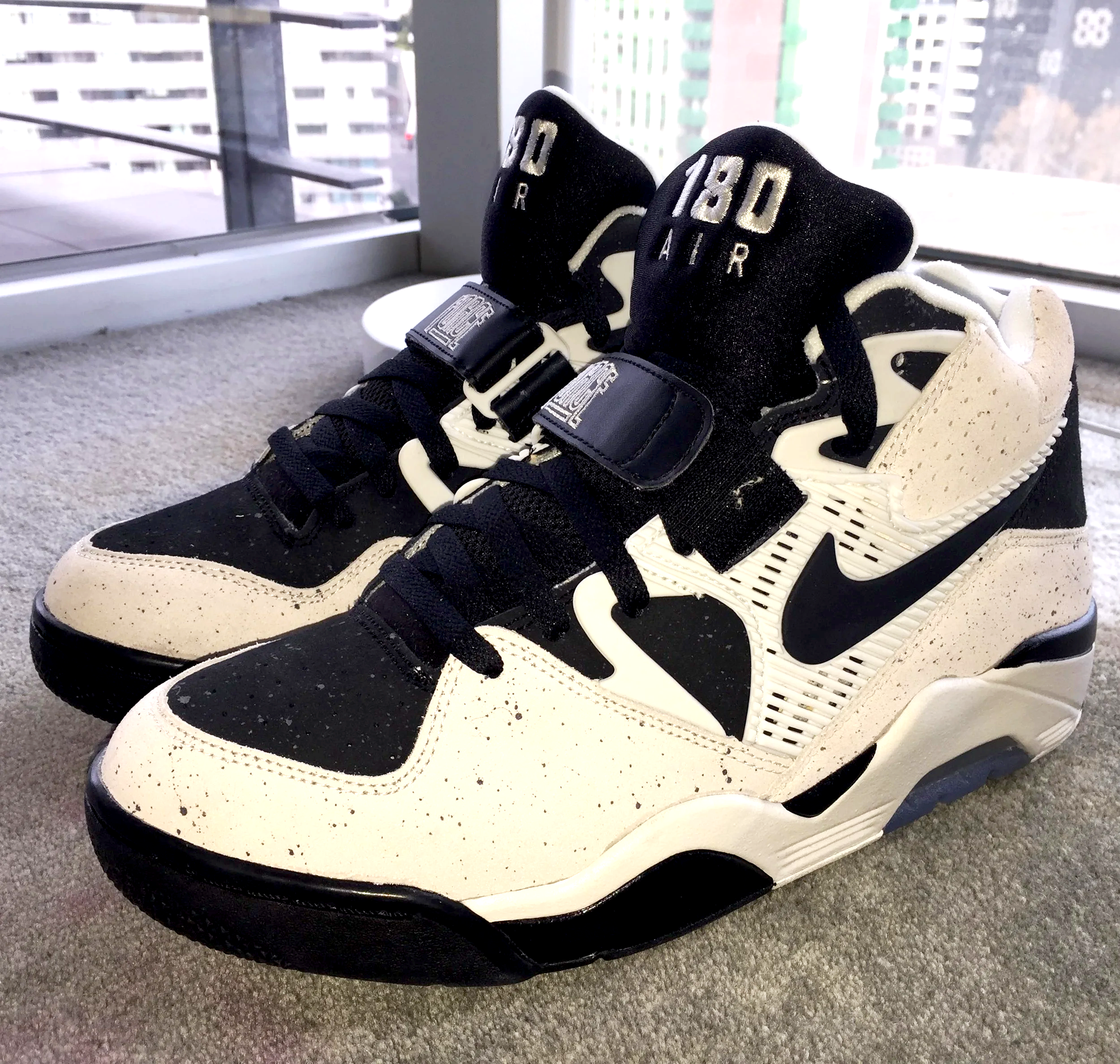 Pair of black and white Nike Air Force 180s
