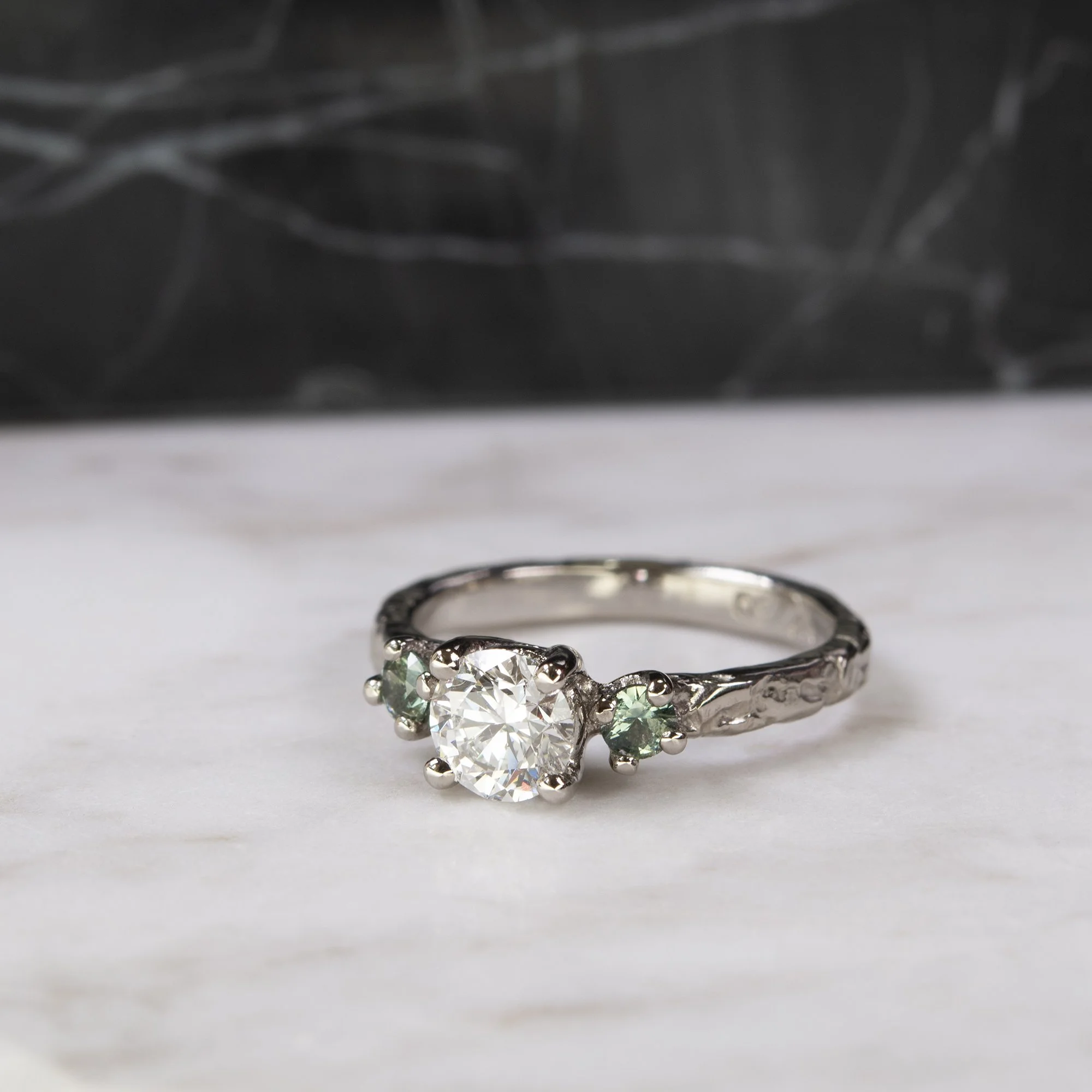 CUSTOM - Earth Frequency Trinity Ring with 0.70ct natural white diamond, teal green sapphires and 18kt white gold.